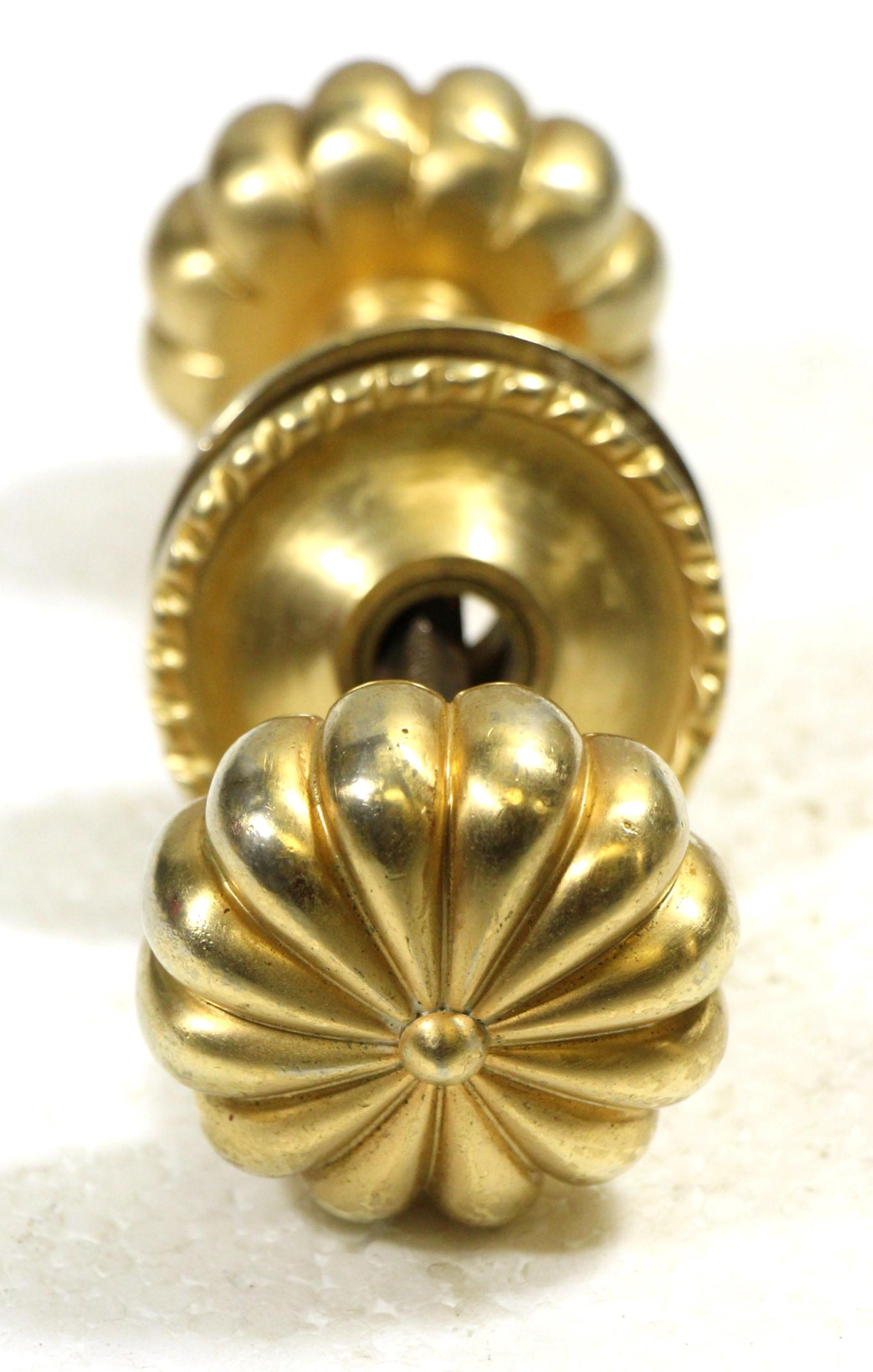Brass doorknob set with beading and fluting. Each set includes five pieces consisting of two knobs with a spindle and two rosettes. Small quantity available at time of posting. Priced each. Please inquire. Please note, this item is located in our