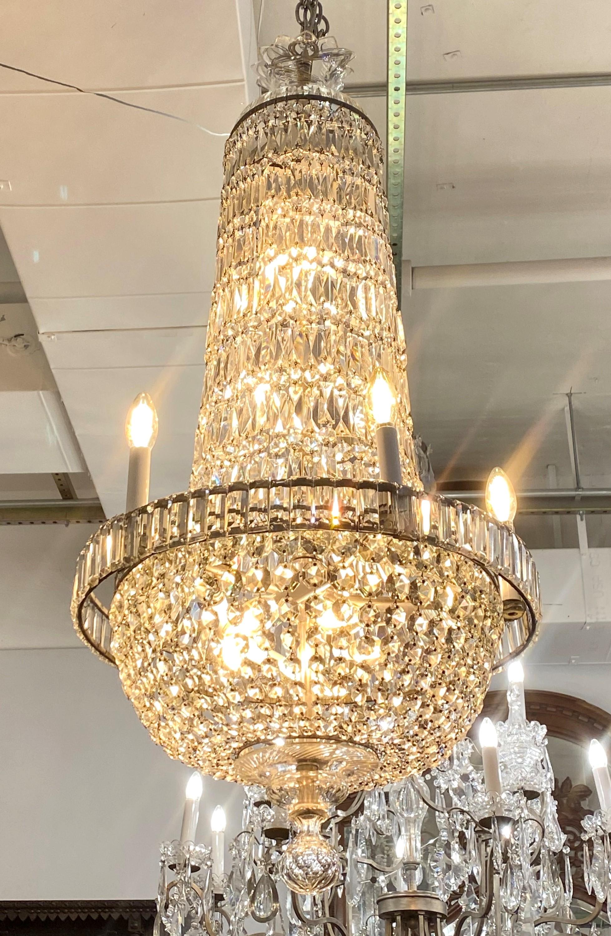 Early 20th century crystal French Empire basket chandelier. Brass finish and the candelabra body. Cleaned and restored. Takes 17 standard candelabra lightbulbs. Please note, this item is located in one of our NYC locations.