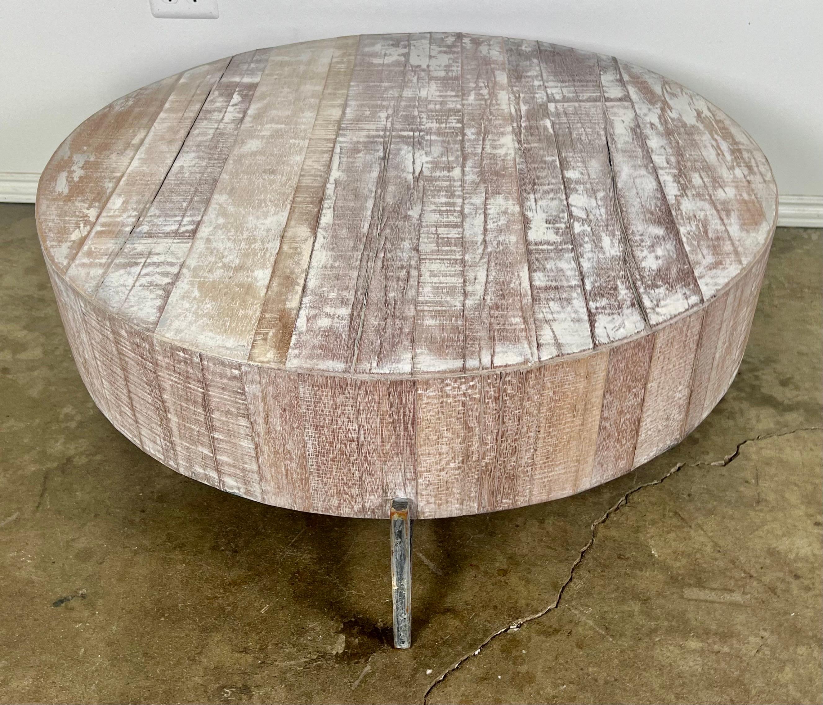20th century round wood primitive coffee table with pewter colored metal legs.