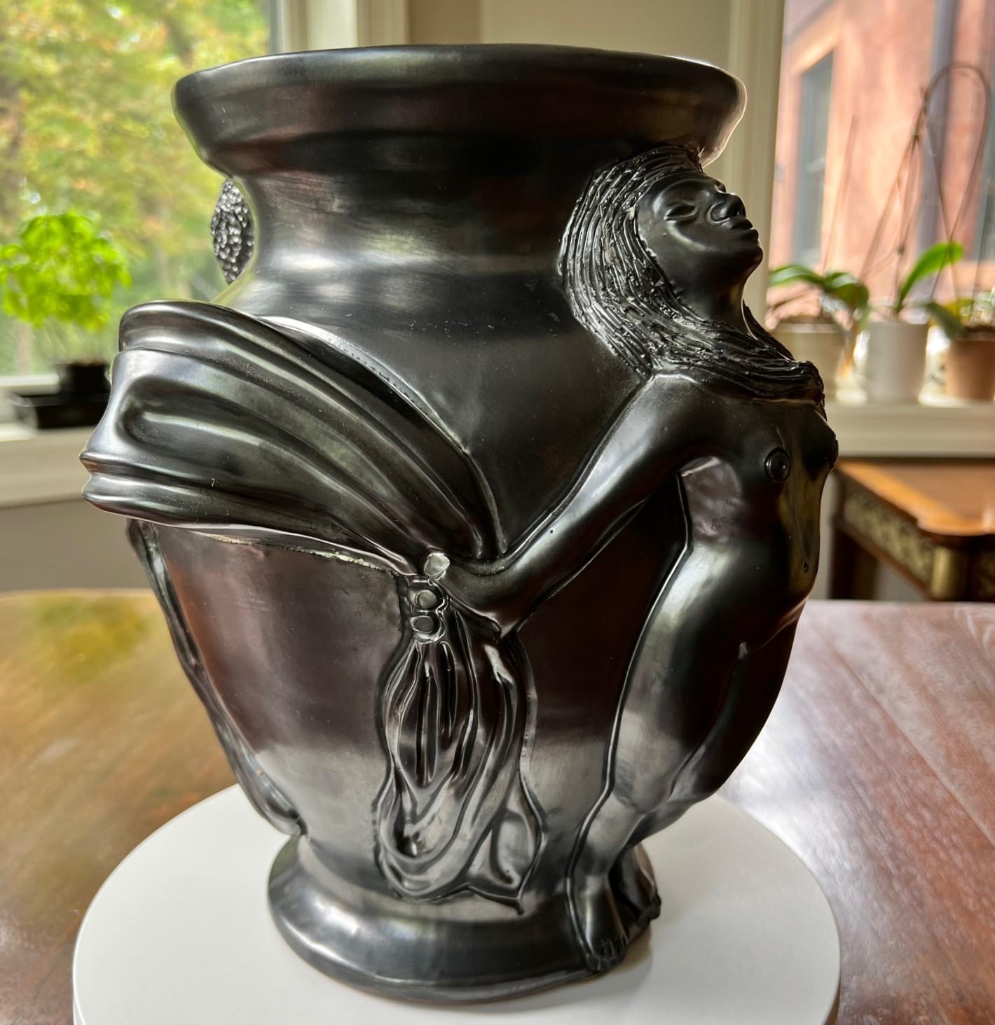 Jean Marais (French 1913-1998), a black lustre glazed terracotta vase of nudes holding draped scarves, c.1960, signed 'Jean Marais'. 

Included in the sale is a hardcover copy of L'Oeuvre Plastique including portraits of Cocteau, Genet, et al,