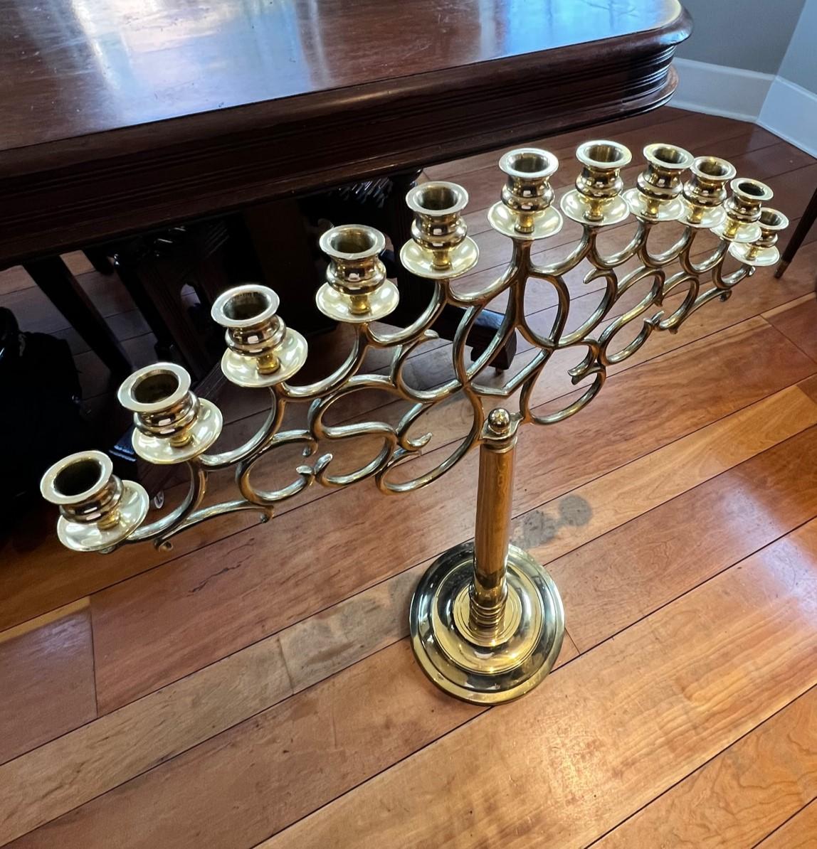 20th century, heavy cast, Eleven-light floor or table candelabrum, with scrolled openwork vine design, in the style of Paavo Tynell, unmarked. There is quate a heft to this candelabrum in terms of the brass weight but there is a certain lightness to