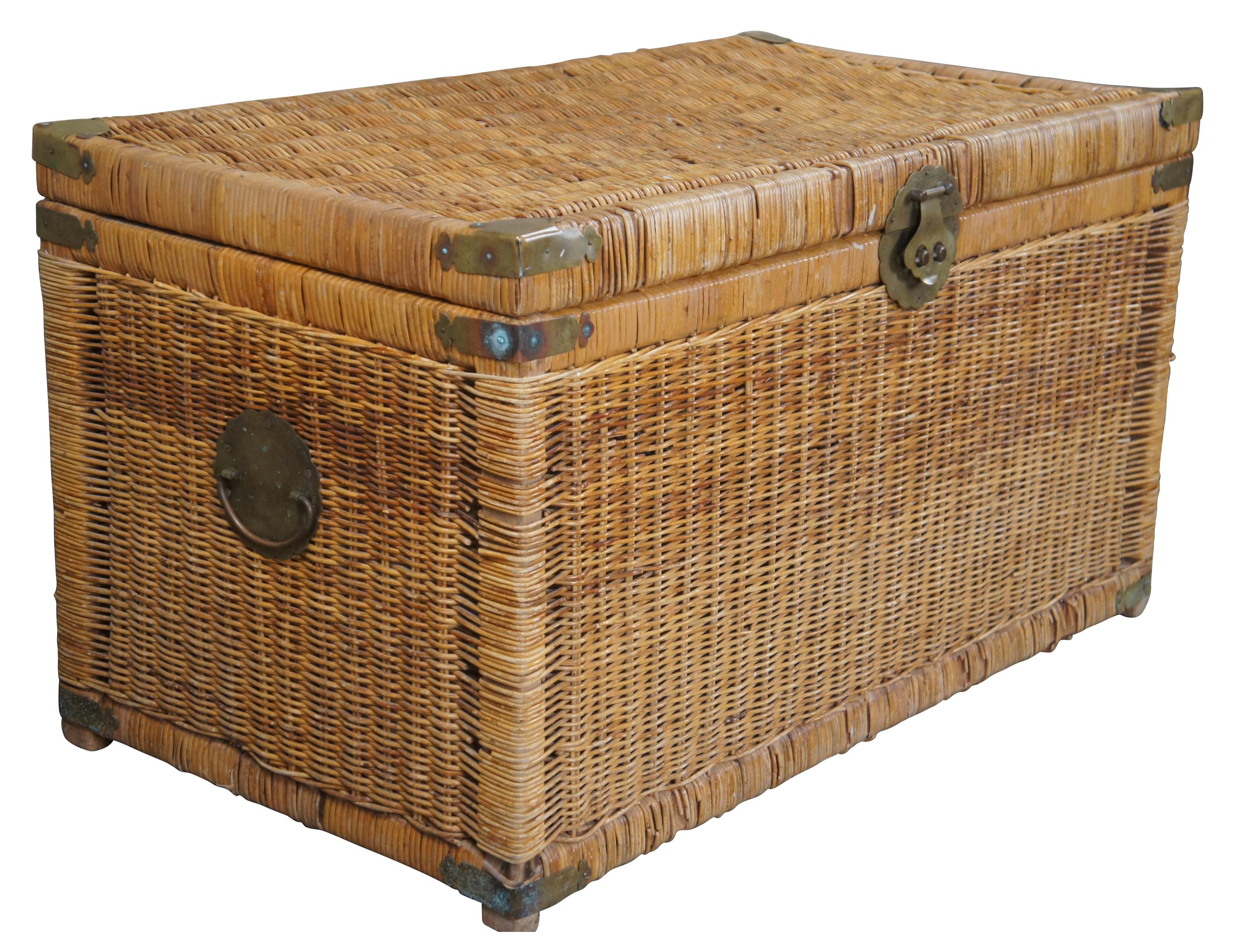 A vintage hand-woven Asian wicker rattan storage chest, 1970s. Ming inspired scalloped brass hardware depicts engraved birds and geometric oriental motifs and symbols.