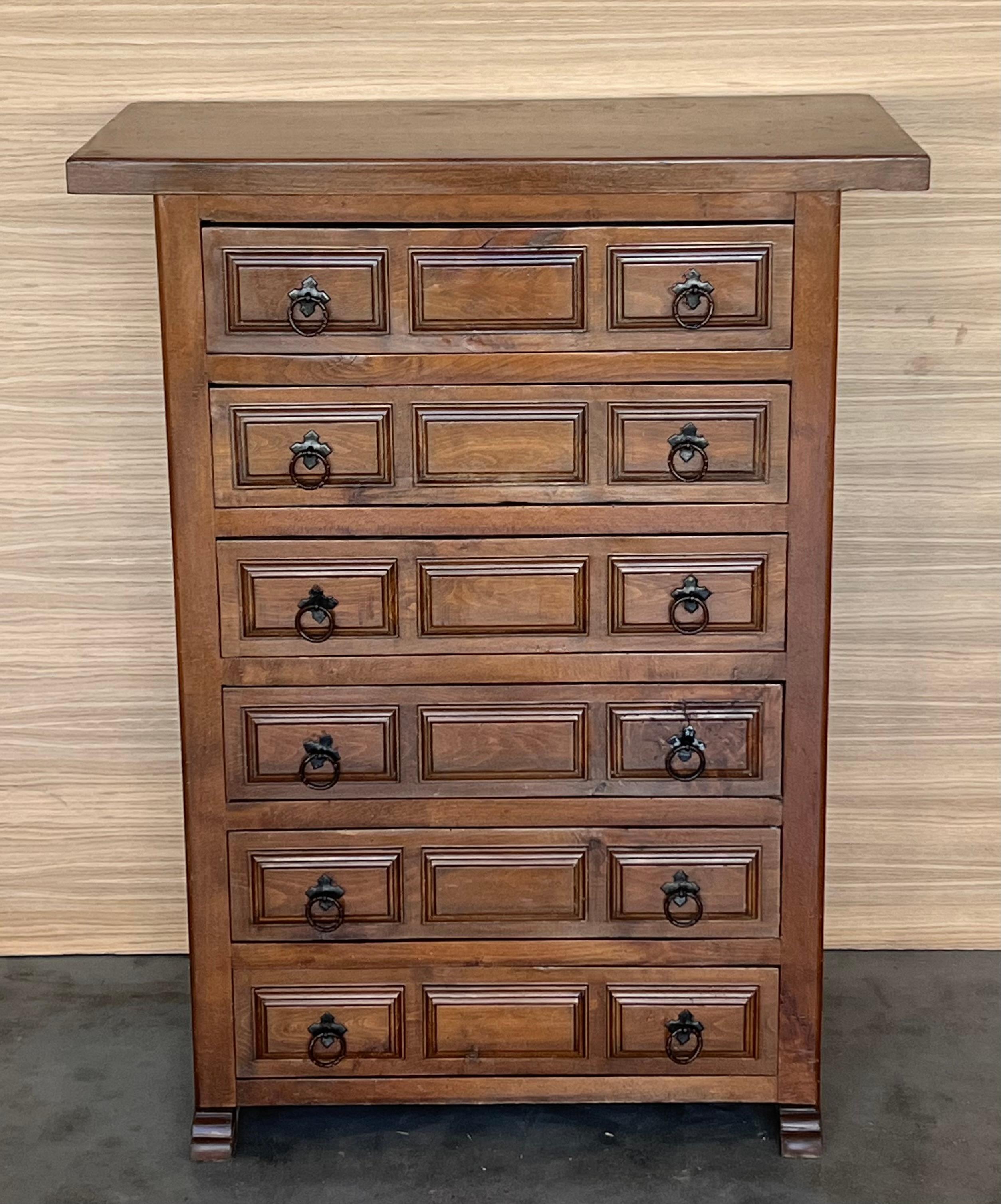 From Northern Spain, constructed of solid walnut, the rectangular top with molded edge atop a conforming case housing six drawers paneled with solid walnut, raised on two plint legs.
Carved on the molding sides , drawers and legs of the front and