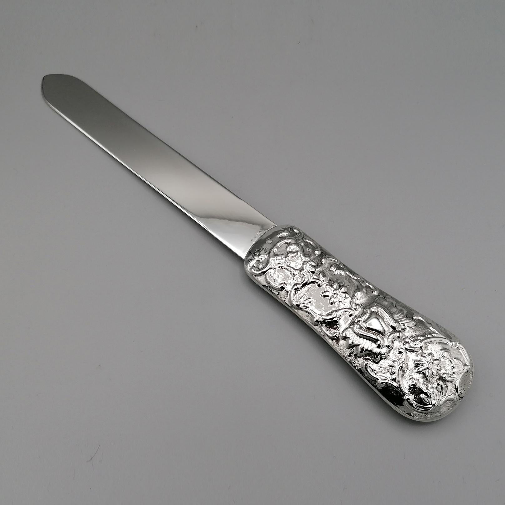 Large, completely handmade, sterling silver letter opener. 
Perfect for a prestigious desk.
The blade is smooth while the hand is embossed by hand on both sides with scrolls and floral motifs.
