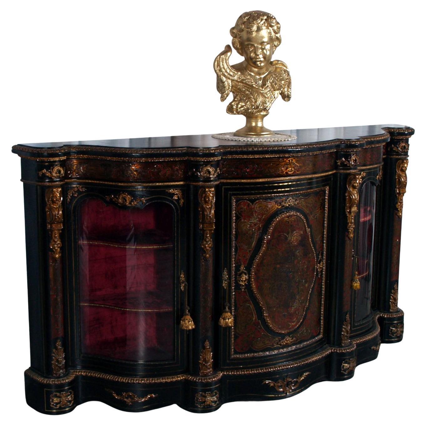 A striking and richly decorated Boulle-style sideboard, crafted in France during the early 20th century and inspired by the opulence of Louis XIV's court. This four-door cabinet features an elegant serpentine front and a bold architectural presence,
