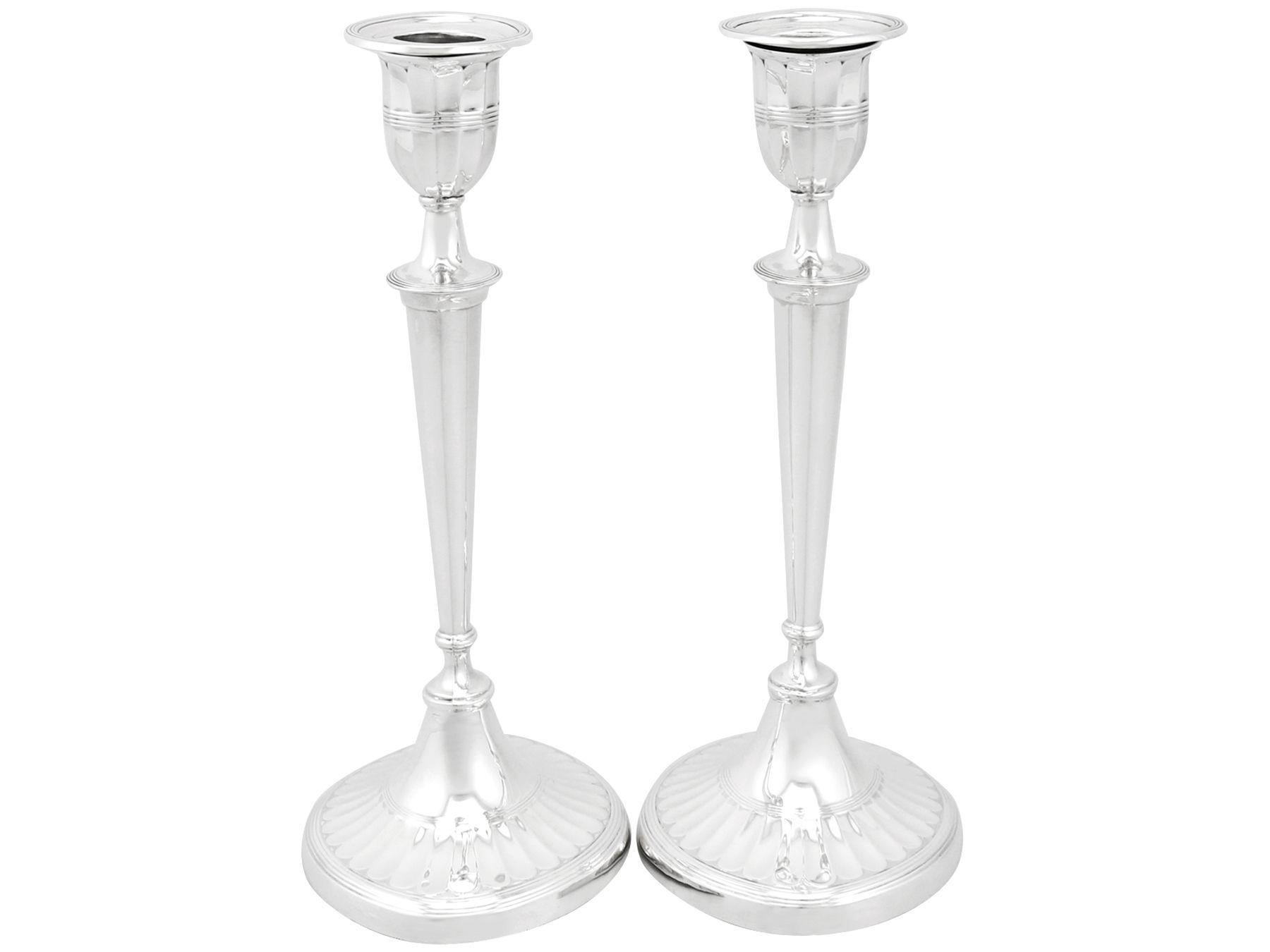 An exceptional, fine and impressive pair of antique Edwardian English sterling silver candlesticks in the Adams style; an addition to our ornamental silverware collection.

These impressive antique Edwardian sterling silver candlesticks have an