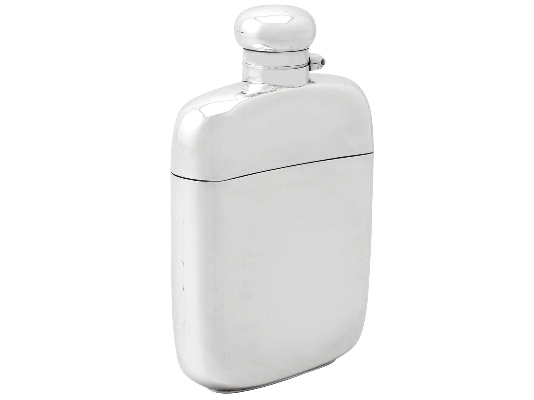 An exceptional, fine and impressive antique George V English sterling silver hip flask, an addition to our wine and drinks related silverware collection.

This exceptional antique George V sterling silver hip flask has a plain rectangular rounded