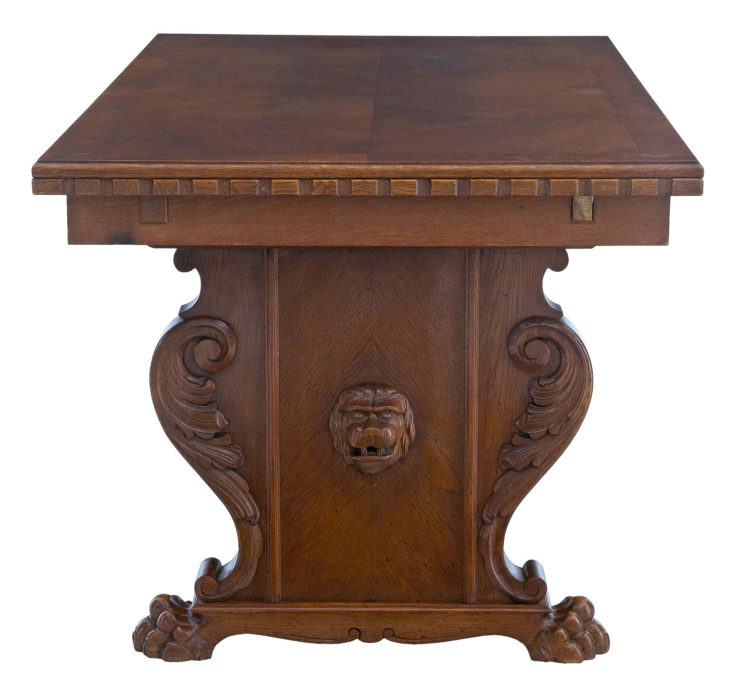 20th century carved oak extending dining table circa 1920.

Carved oak trestle end table, oak top with pine drawleaf slides which is normal for swedish made furniture.

Applied carved scrolls and lion head, standing on carved lion paw