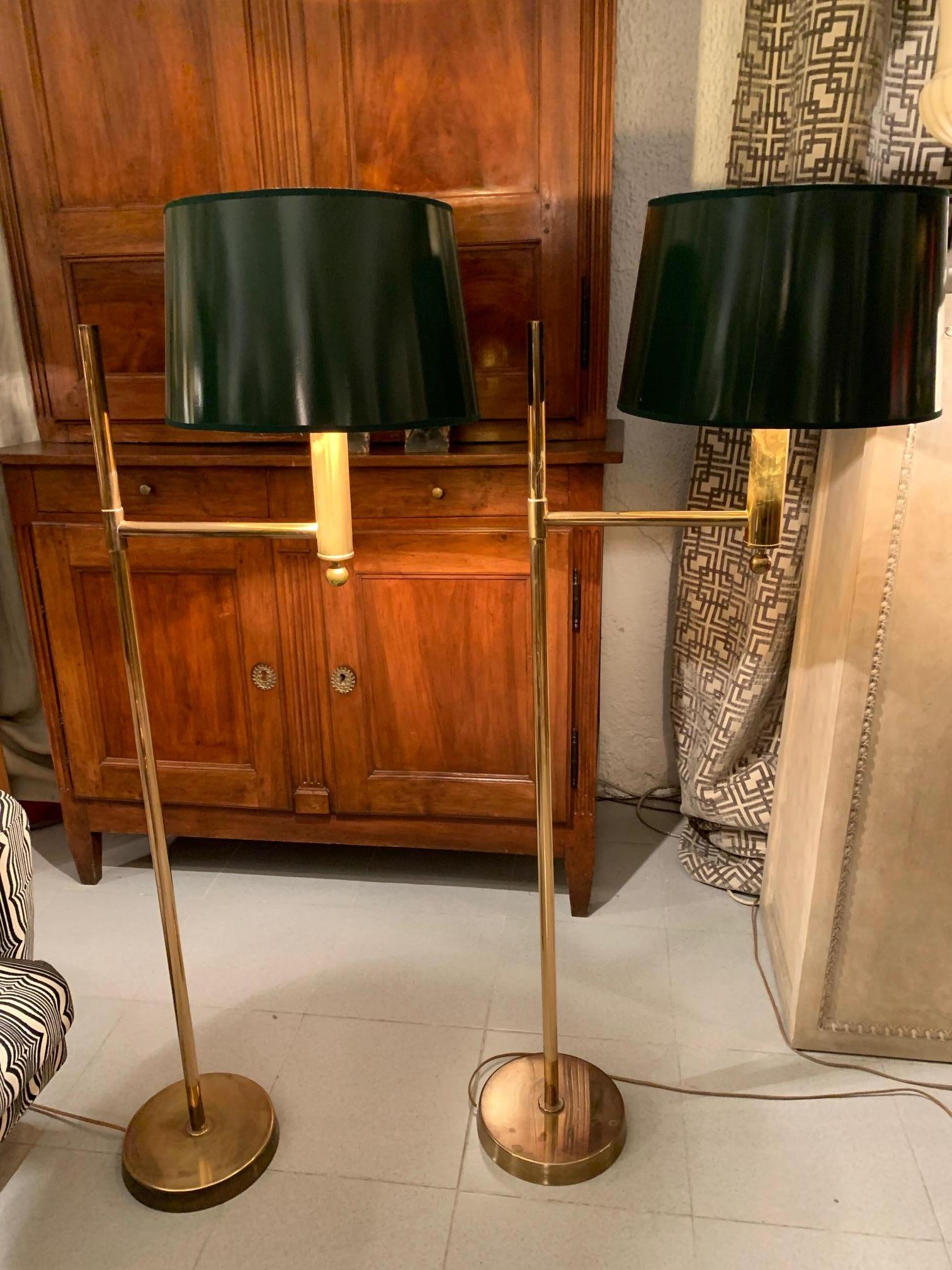 A pair of swedish floor lamps in brass, by Bergboms, the lamps have an arm that supports a small column ending in a ball, which supports the lampshade
in this case the lampshade is in green patent leather and its gold interior.
The measurements of