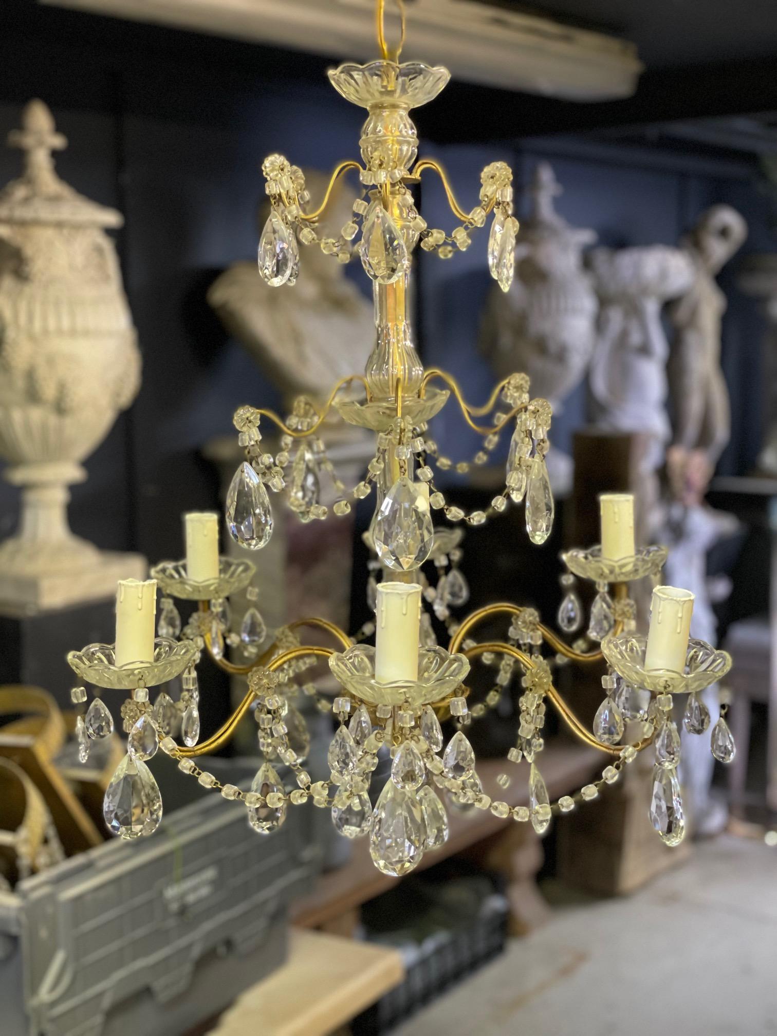 A very elegent mid-20th century glass and gold framed Italian chandelier holding x6 arms.

Height includeds chain and ceiling rose so can be altered.

Removed from a private estate in Chigwell Essex, United Kingdon.