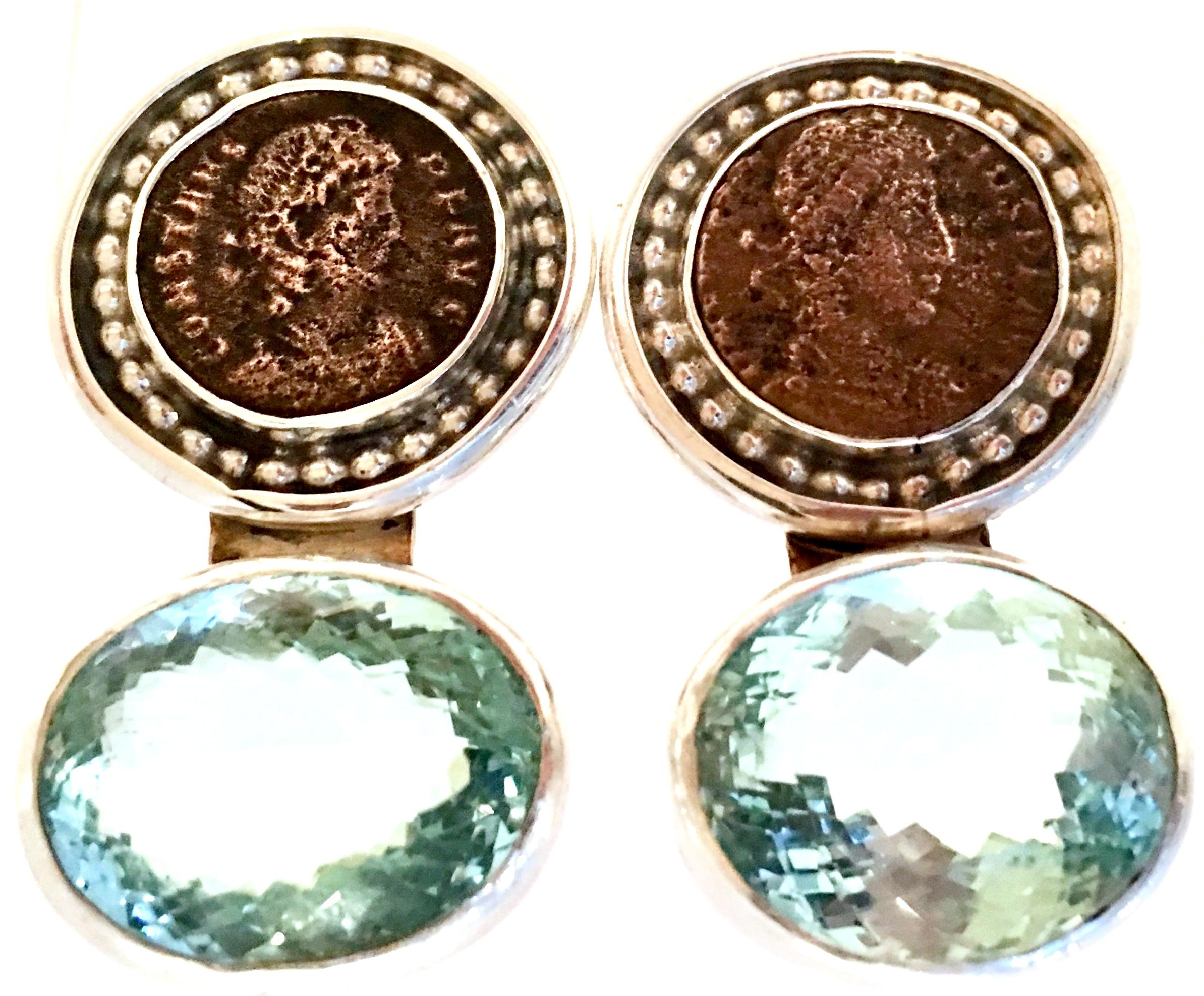20th Century 925 Sterling Silver & Aquamarine, Bronze Roman Coin Clip On Earrings By, Rebecca Collins. These iconic Rebecca Collins Design Bronze Roman Coin, Brilliant Cut and Faceted Aquamarine stone earrings are set in 925 sterling silver. Each
