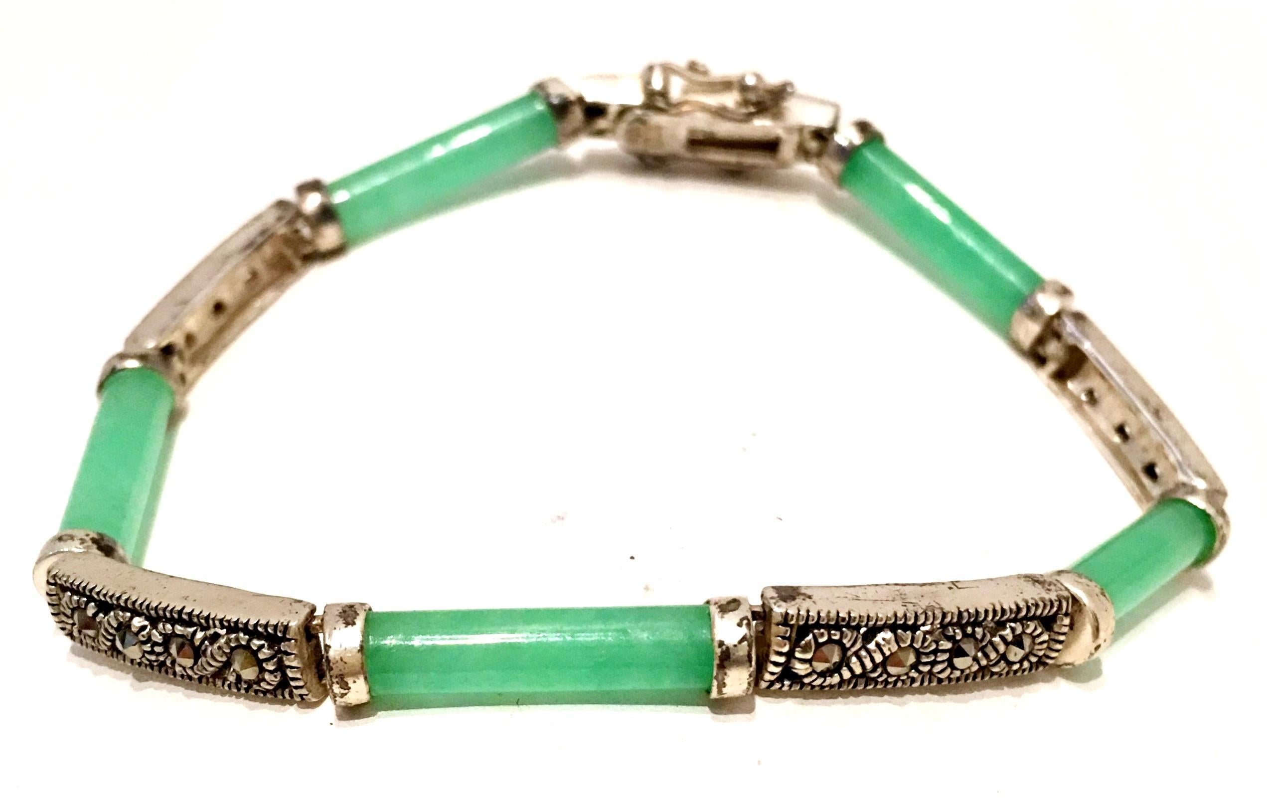 20th Century Chinese 925 Sterling Silver, Jadeite And Marcasite Link Bracelet. Features, five green jadeite links and four sterling with four marcasite stones each. Each link is approximately .75