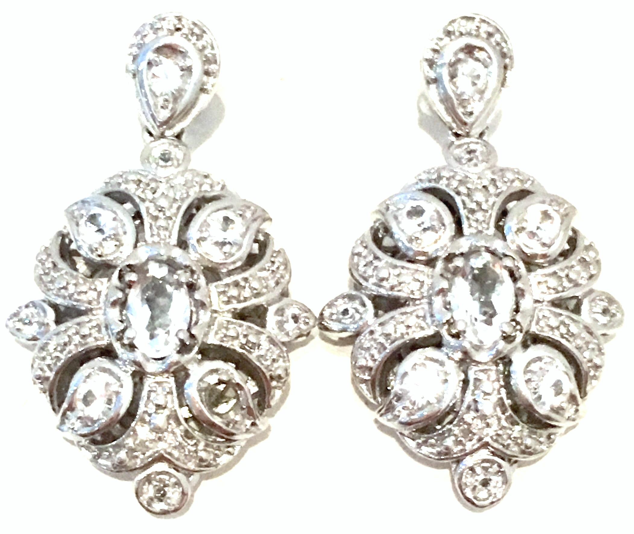 20th Century Sterling Silver & Austrian Crystal Ring & Earrings Set Of Three Pieces.
This three piece set features 925 sterling silver filigree work with brilliant, colorless Austrian crystal and marcasite detail. The pierced style chandelier