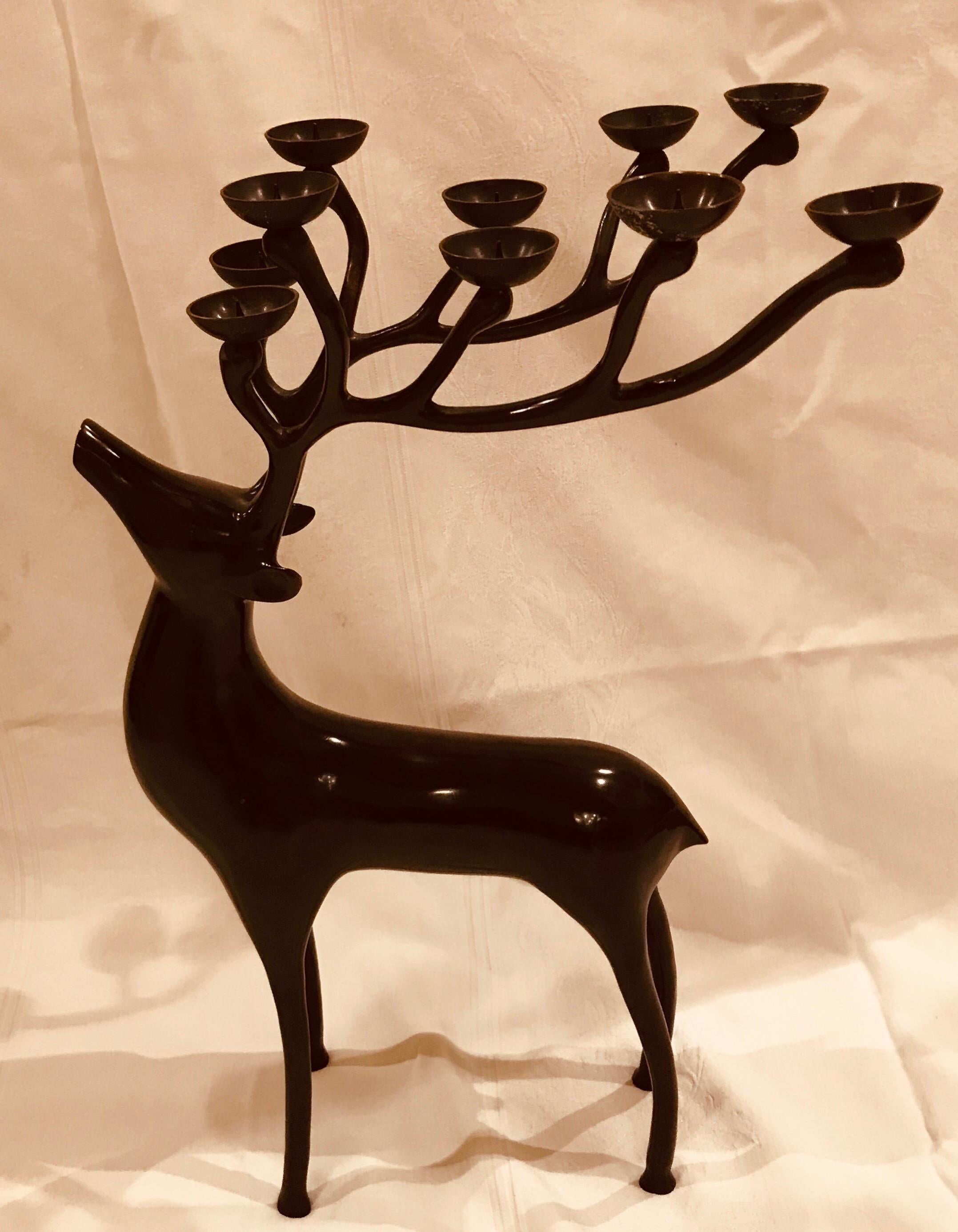 These dark oiled bronze Abstract Reindeer candelabras each hold 10 candles. 20” high, with an 11.5” antler spread, they are weighty and impressive on a hall entry table or placed beside a Christmas display.

Made in the mid-1990s, these large