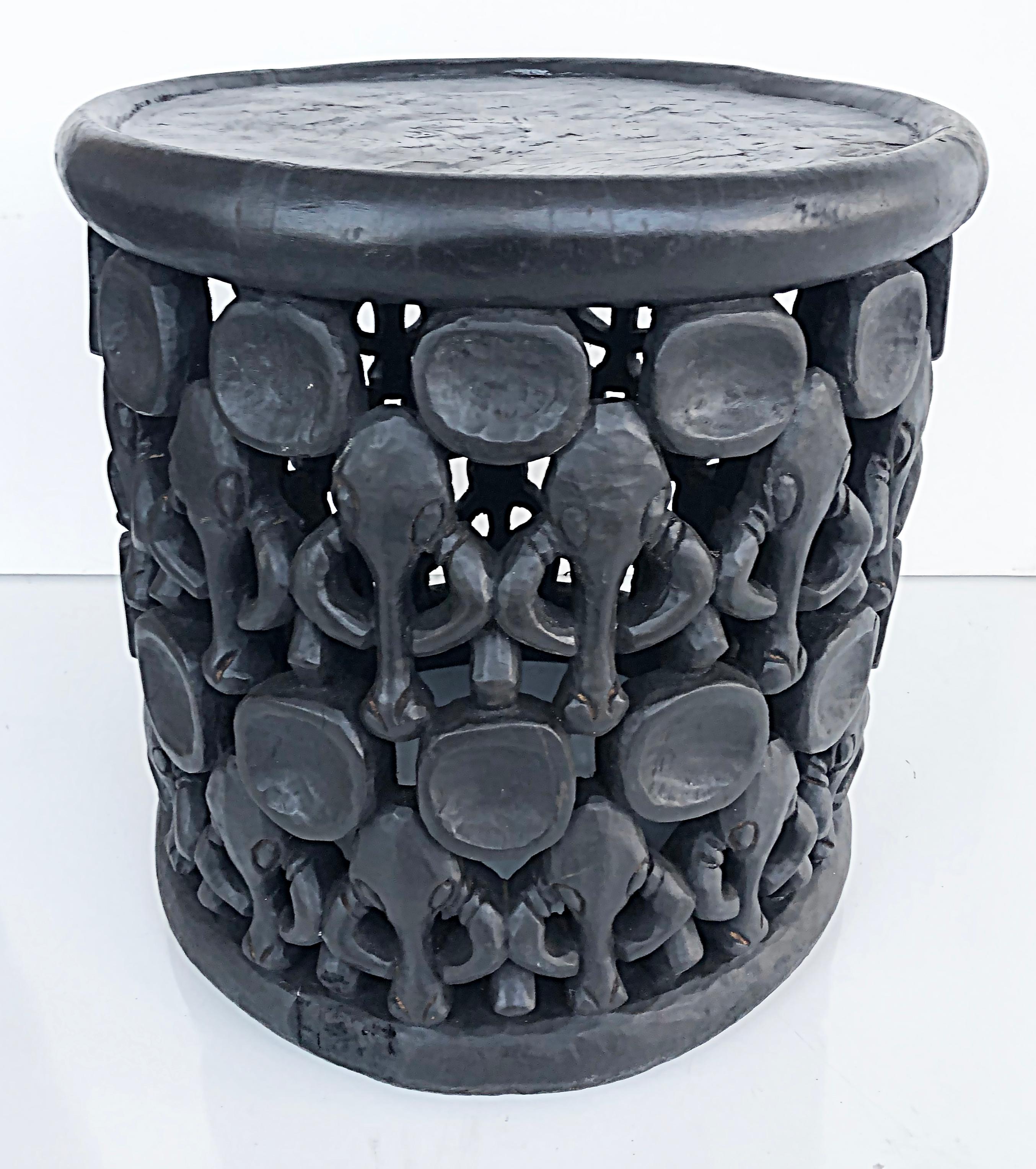 Modern African Bamileke table/stool with elephants.

Offered for sale is a modern mid to late 20th-century rare carved African wood side table or stool created in by the Bamileke people. The table is surrounded by carved elephants and is carved from