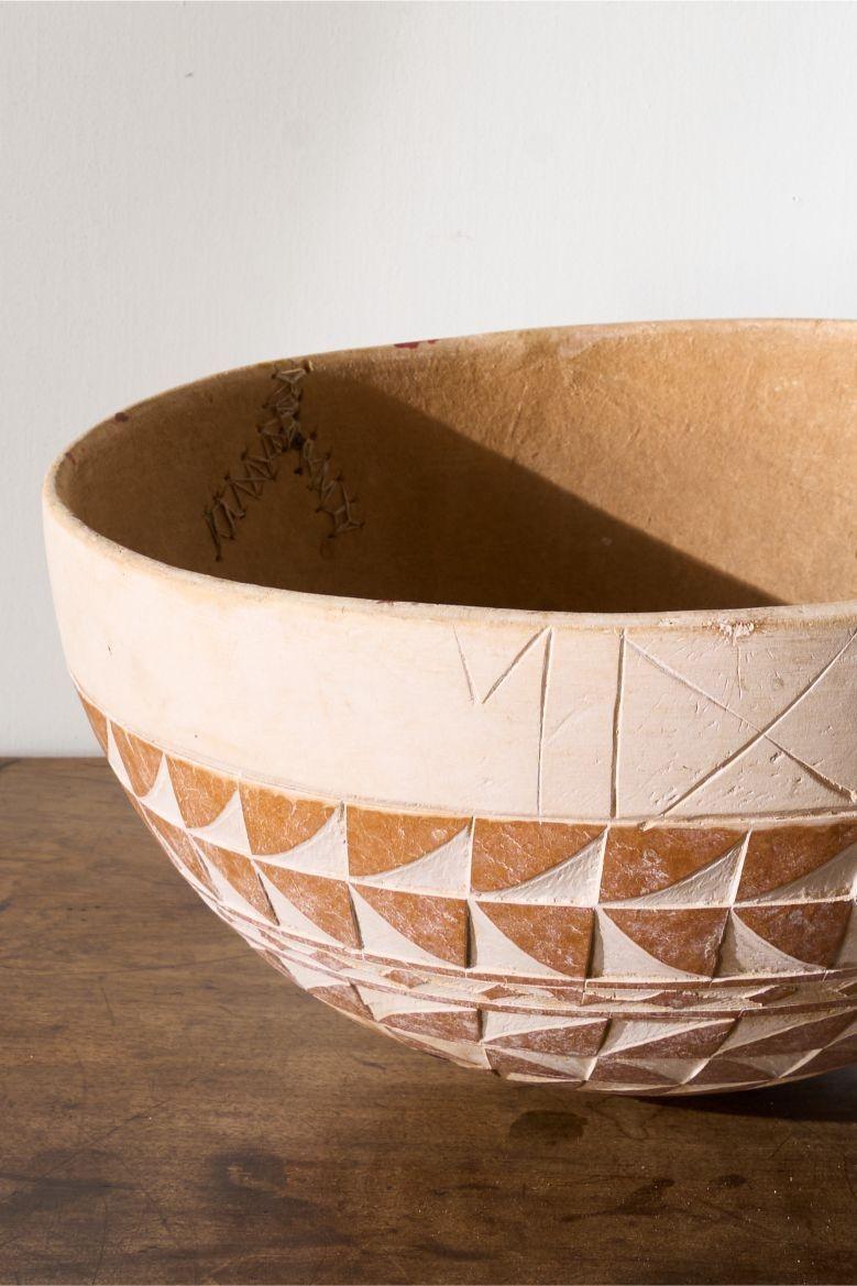 This is one of three 20th century African carved Gourd bowls we have in stock. The geometric patterns and colours make these hugely decorative. These bowls are a large size also meaning you can use them as a fruit bowl or just leave them as