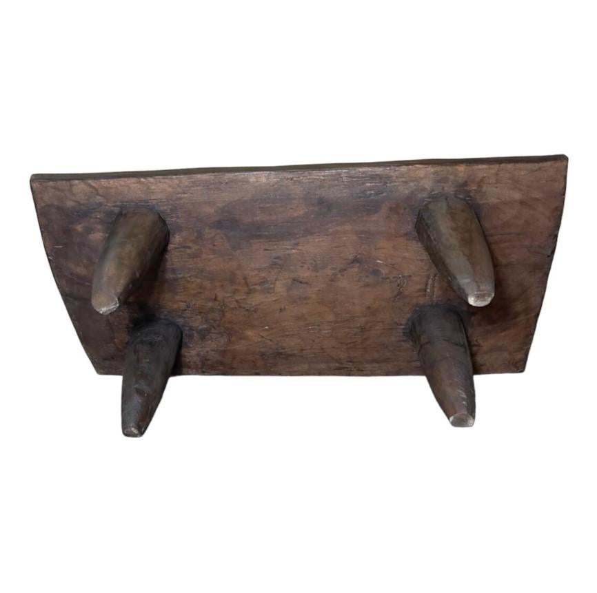 20th century African Senufo bench / coffee table made in Africa in the Cote d'Ivoire. Expertly carved from a single piece of dark wood. Amazing piece that can be used as a bench or coffee table.