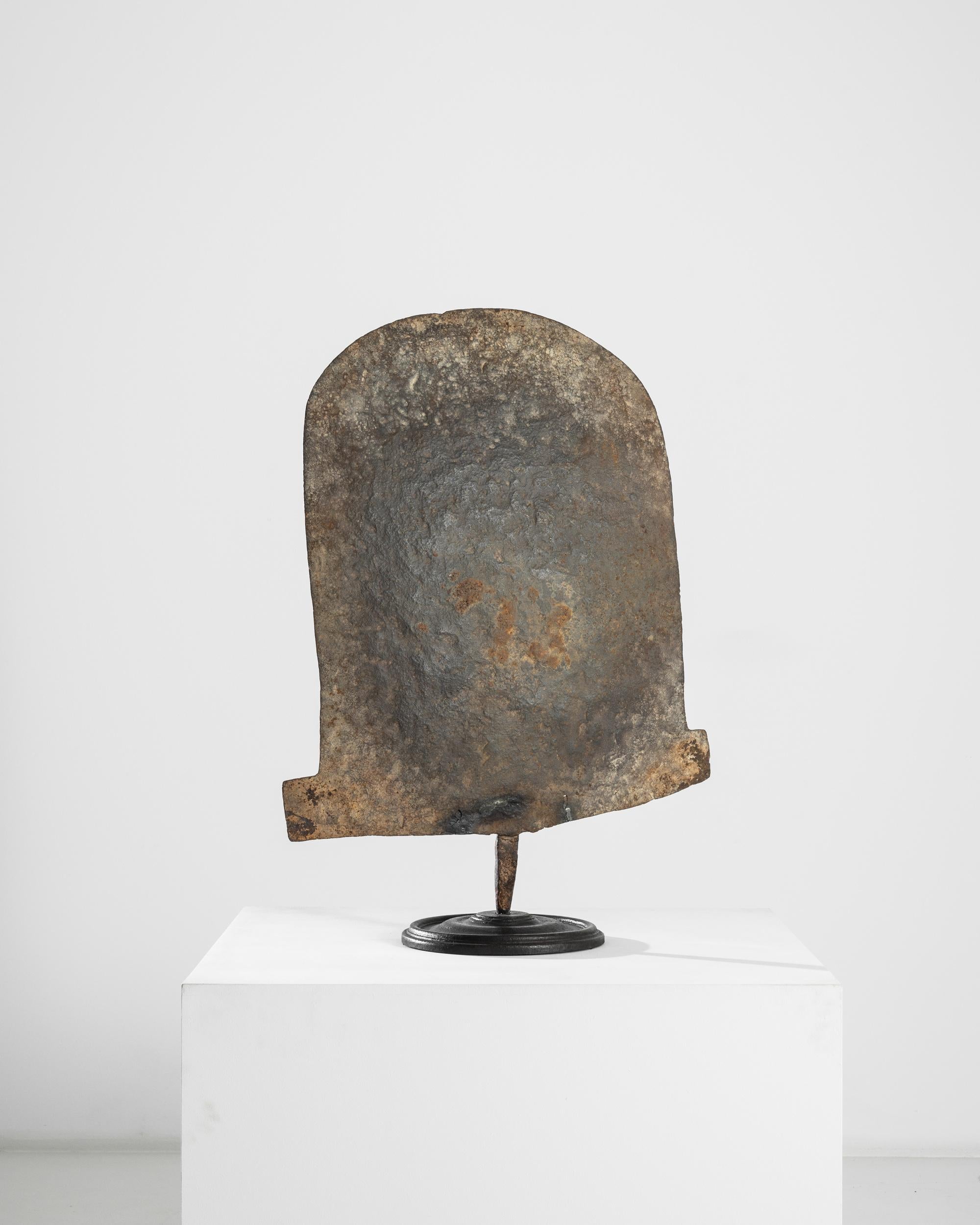 This fascinating piece is an example of shovel currency, formerly used among the peoples of northern Nigeria as a form of monetary exchange. Forged iron would have been traded for goods or used in wedding negotiations — and the large size of this