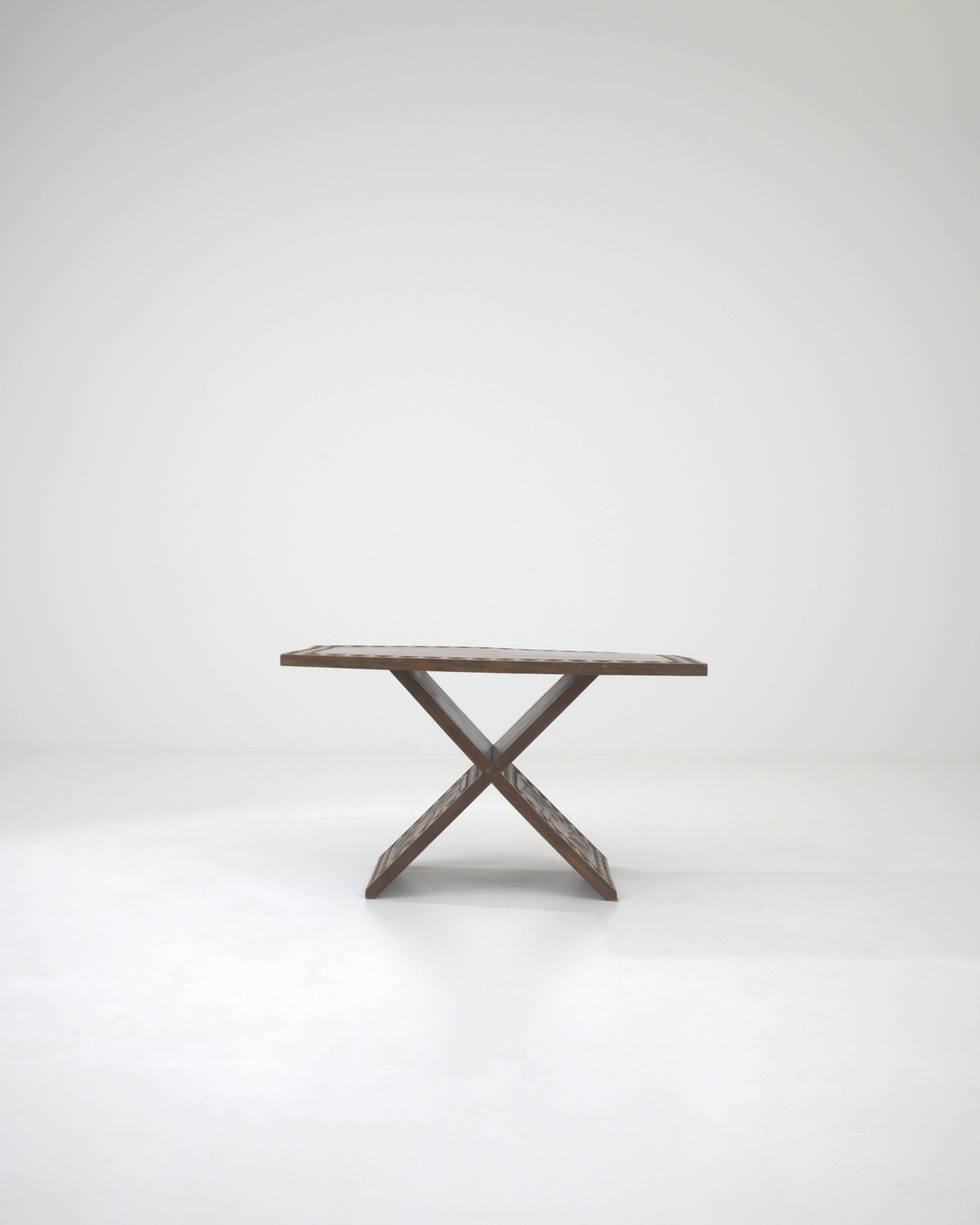 This 20th Century African Wooden Coffee Table with Original Patina offers a captivating blend of artistry and heritage. Its X-shaped base and square top exude elegance, while the intricately carved rhino on the side adds a touch of African