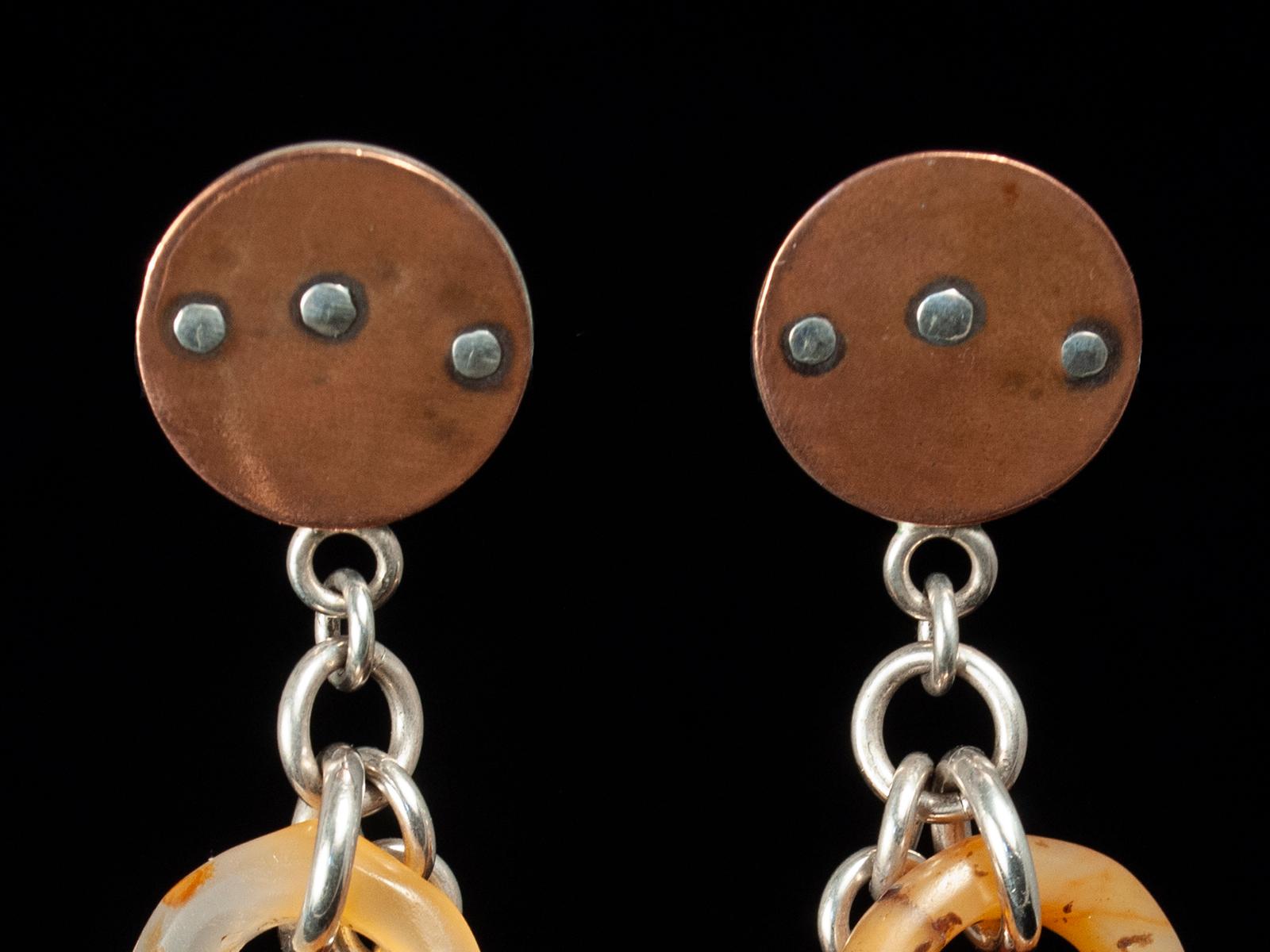 20th Century Agate and Silver earrings by Jewels

Four rare hair ornaments carved in agate, called Tanfouk or Talhakimt, drop from a copper and silver disk for a pair of lightweight earrings. These ornaments were worn by women in Mali and