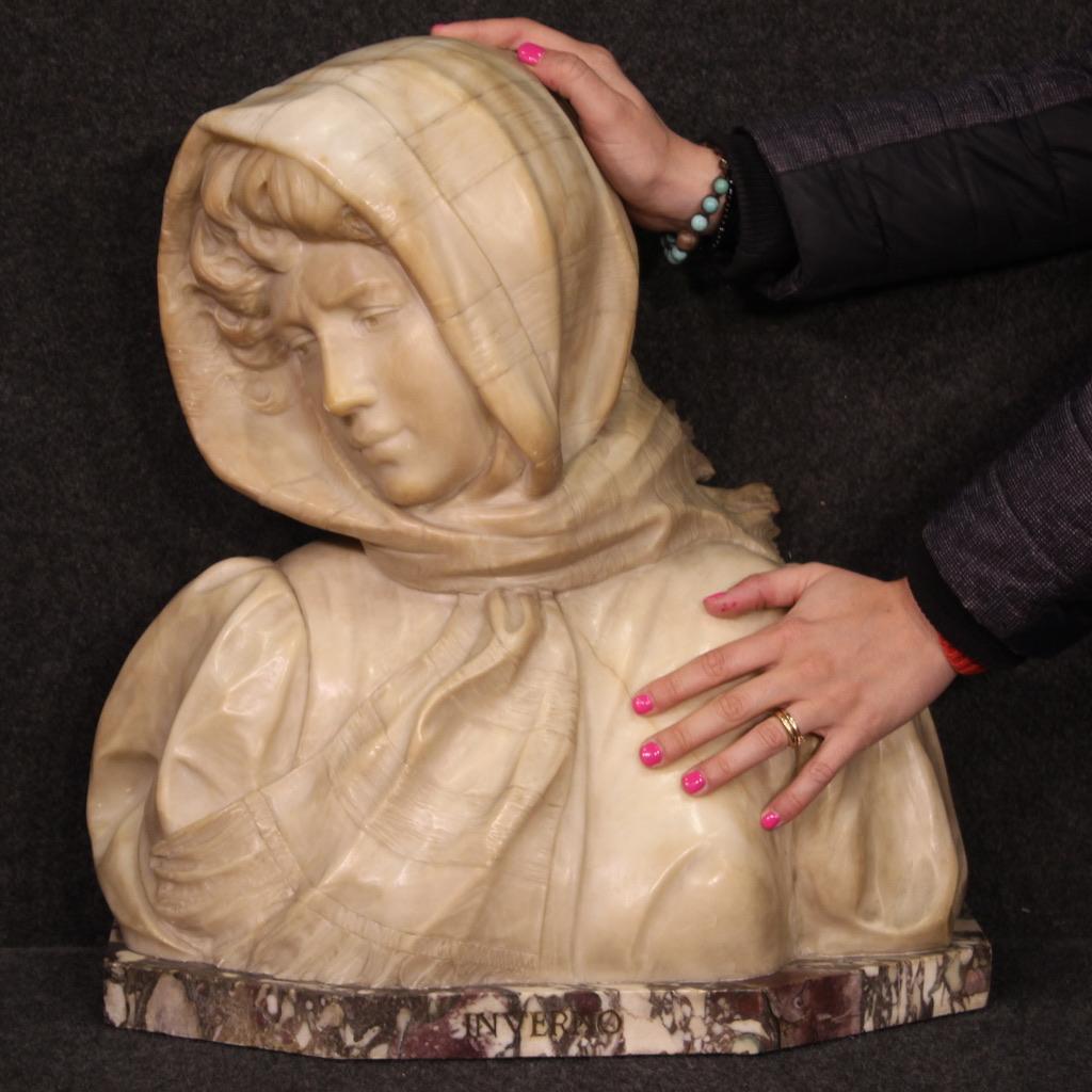 Elegant Italian sculpture from the first half of the 20th century. Work finely sculpted in alabaster depicting the allegory of winter. Finely crafted statue of a young girl in vintage winter clothes moved by the wind. Base in peach blossom marble