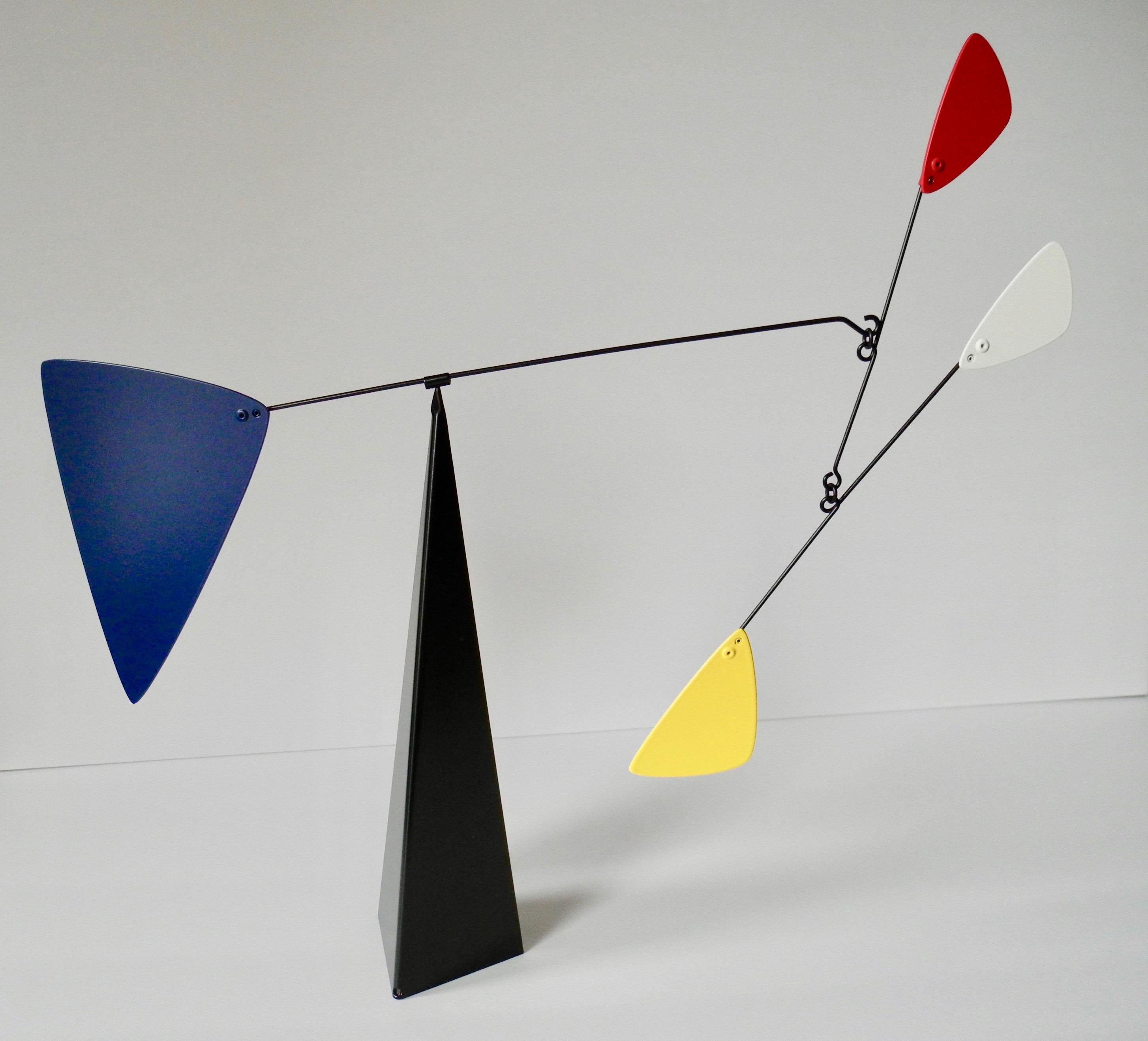 This tabletop free standing kinetic mobile is made of metal and three painted primary colors; red, yellow and blue on a black base. Very reminiscent of Alexandre Calder's sculptures and kinetic mobiles. Beautifully crafted and in like new condition.
