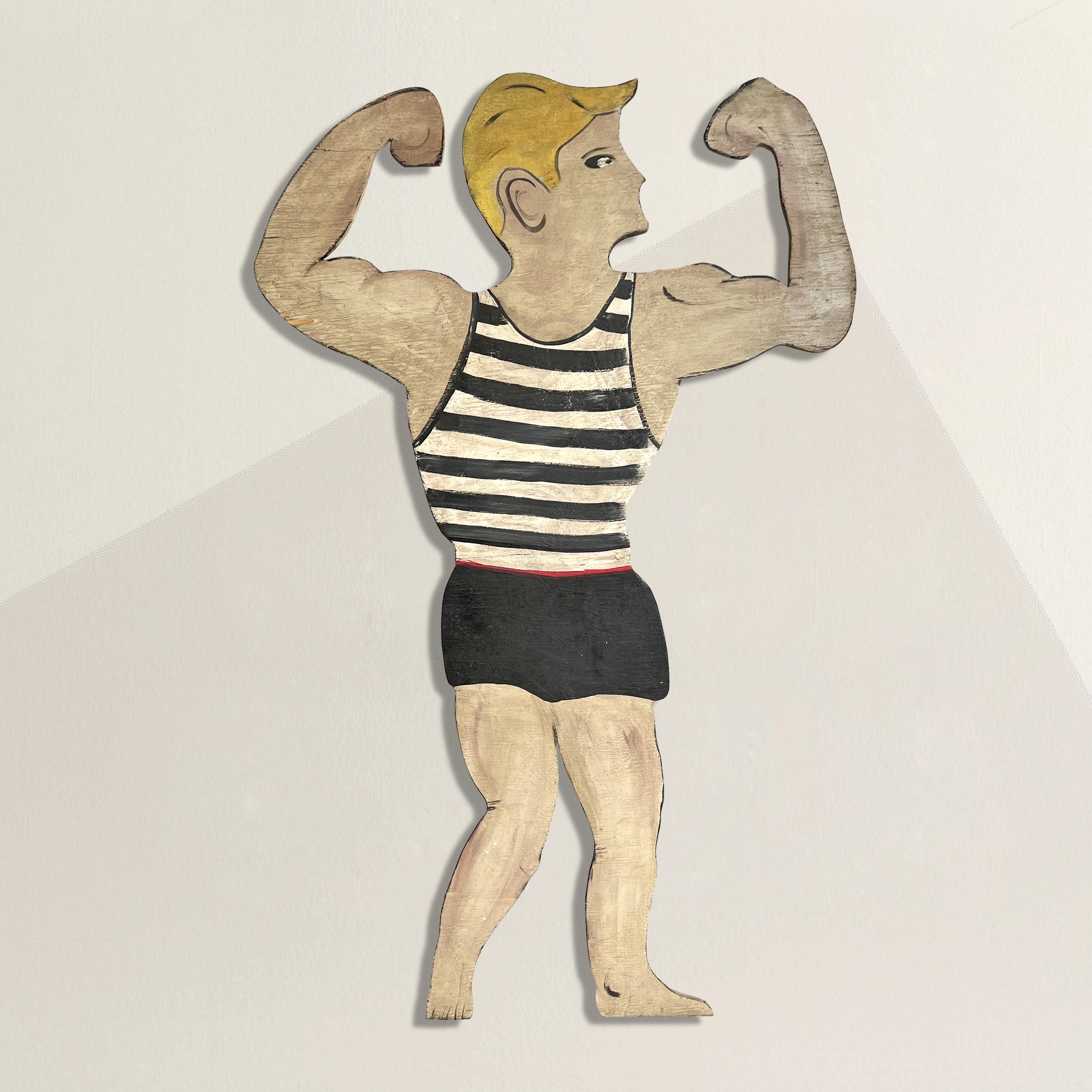 A playful and cheeky mid-20th century American Folk Art wooden cutout of a blond swimmer flexing in his black and white striped swimsuit, mounted on a custom steel wall mount so he can be hung anywhere you wish.