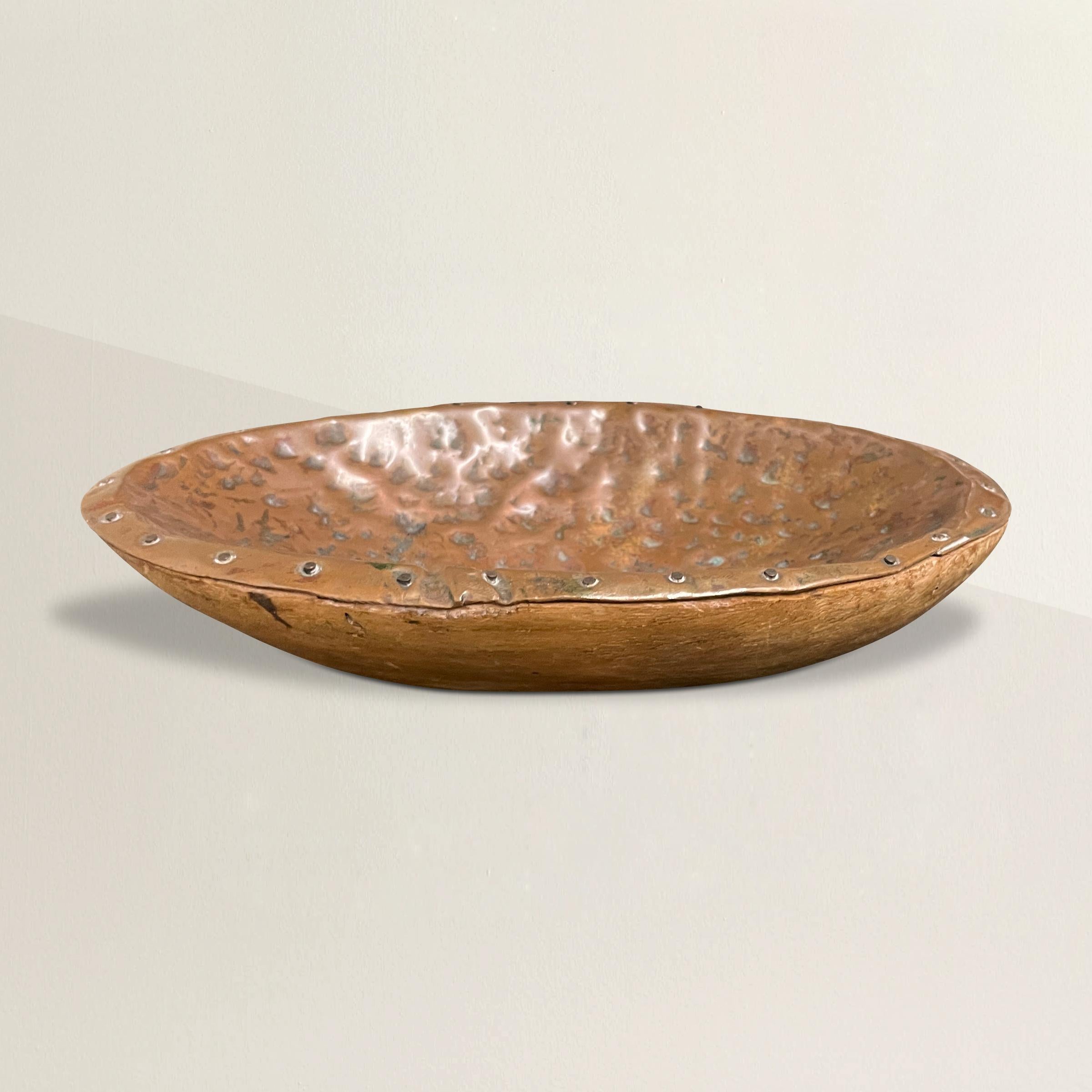 A quirky yet charming 20th century crudely hammered copper lined wood bowl with a wonderful texture. Perfect for catching your keys on your entry console, or holding your glasses on your nightstand.