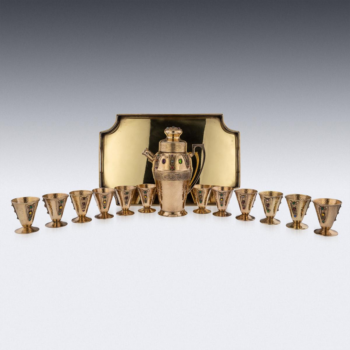 20th Century American Jugandstil richly gilded on copper cocktail shaker with twelve goblets on tray. Made in a very unusual and distinctive style called Jugendstil (