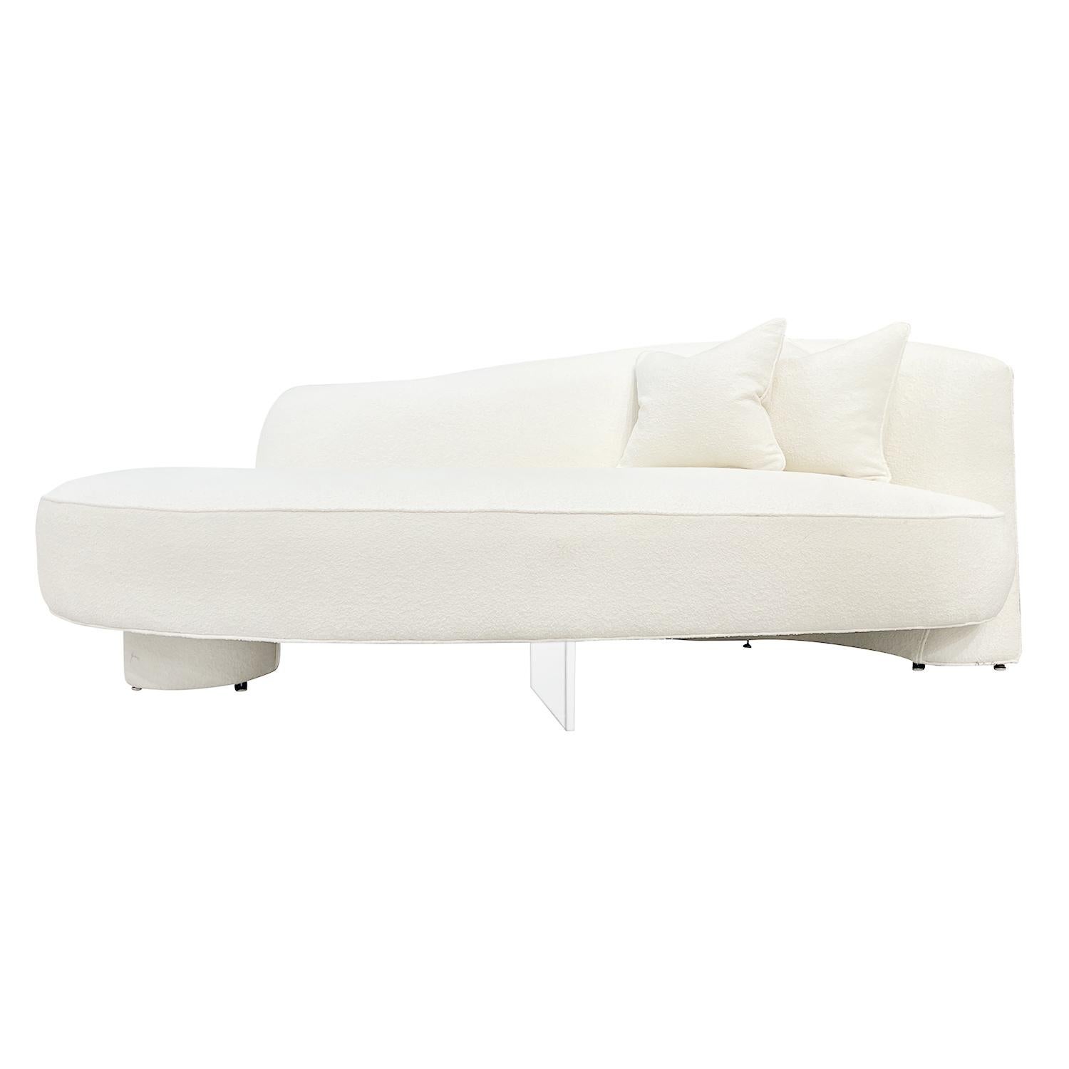 A vintage Mid-Century Modern American four seater Serpentine sofa with two pillows, designed by Vladimir Kagan and produced by Directional in good condition. The seat backrest of the sculptured settee, canapé is arched resting on two wide