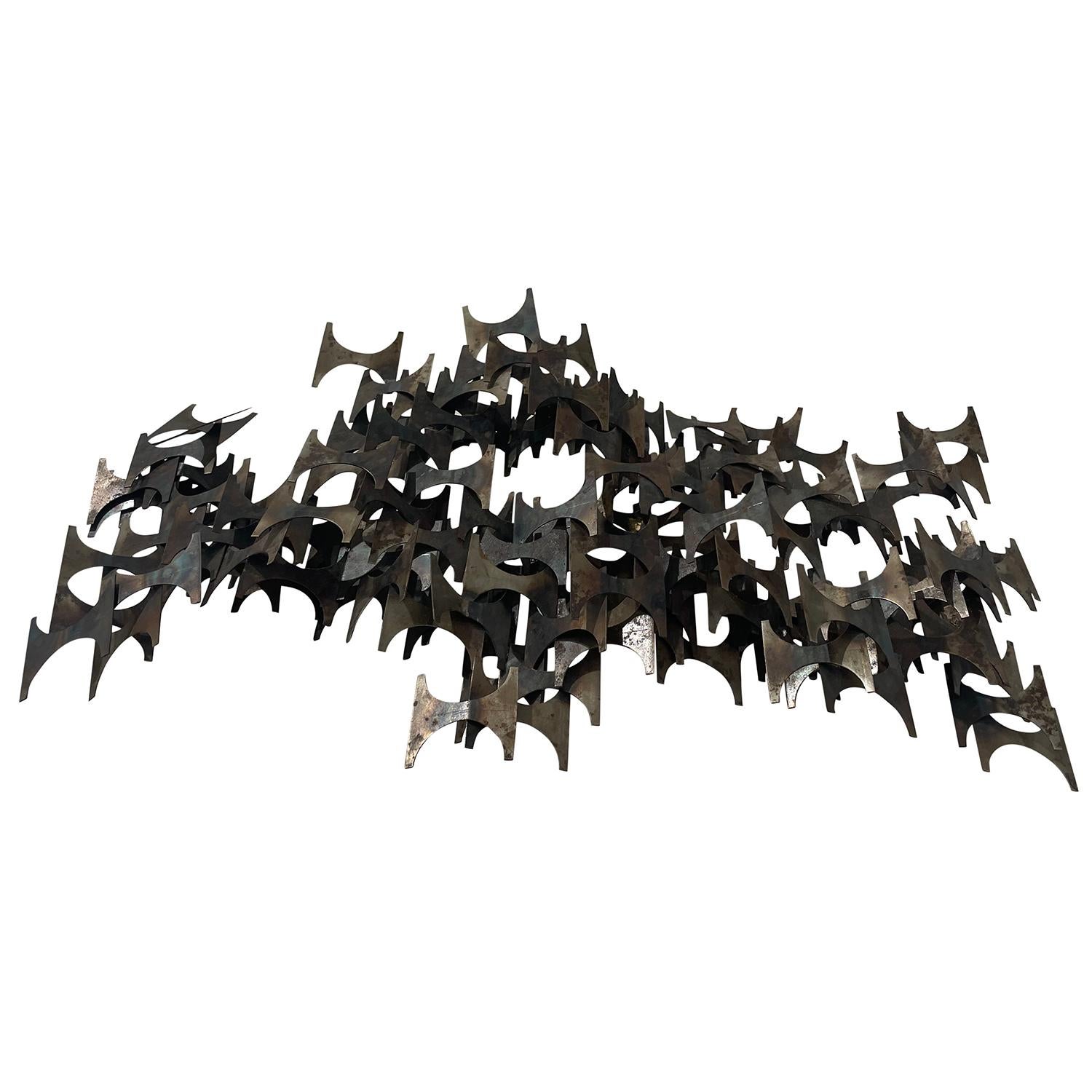 A vintage Mid-Century modern American wall sculpture made of hand crafted metal designed and produced by Marc Weinstein, in good condition. The abstract Brutalist décor piece is composed by many small metal pieces. Wear consistent with age and use.