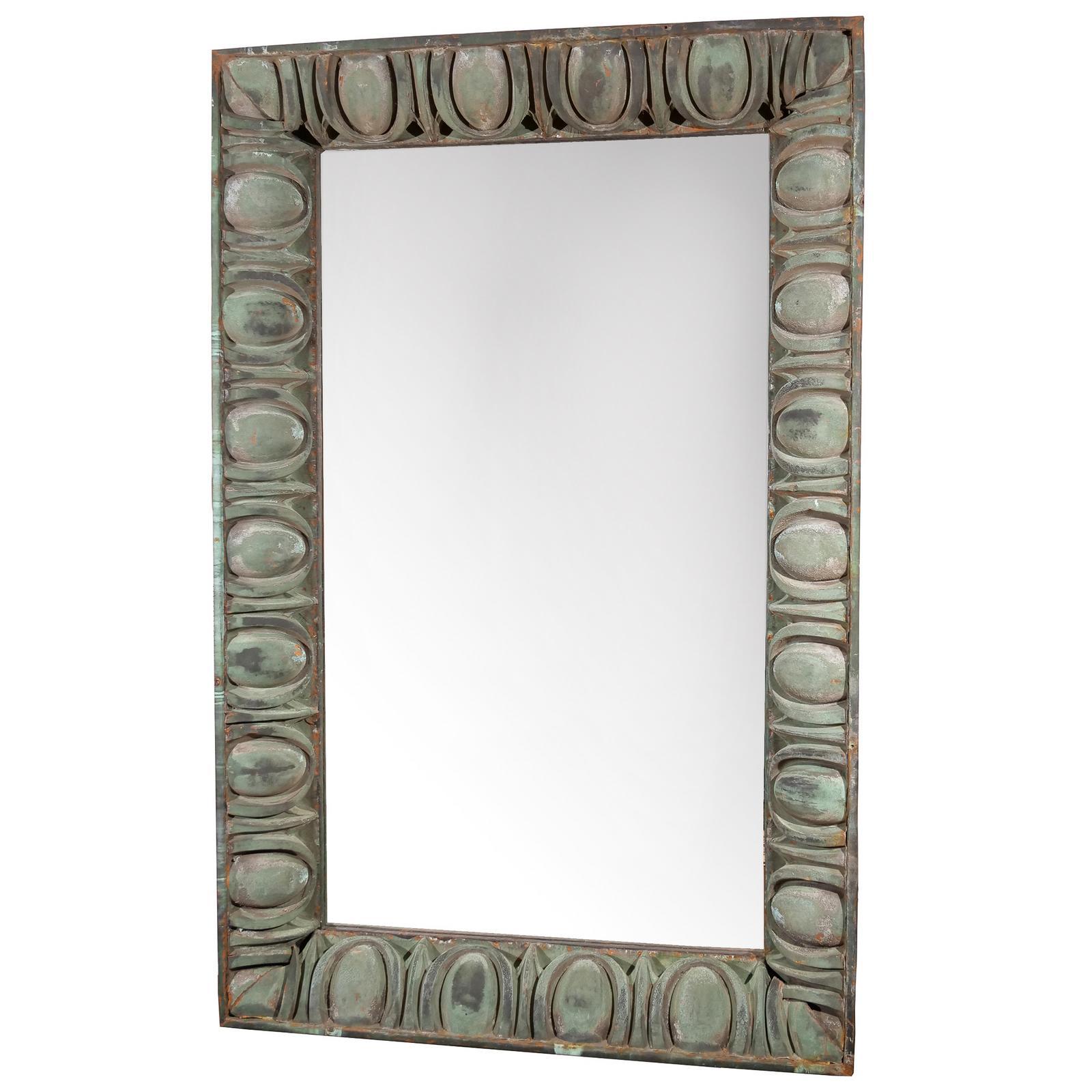 A light-grey, green oversized Art Deco American wall mirror made of hand crafted metal with its original mirror glass, in good condition. The floor mirror belong to the Rialto Theater, enhanced with egg-and-dart patterned copper border, designed and