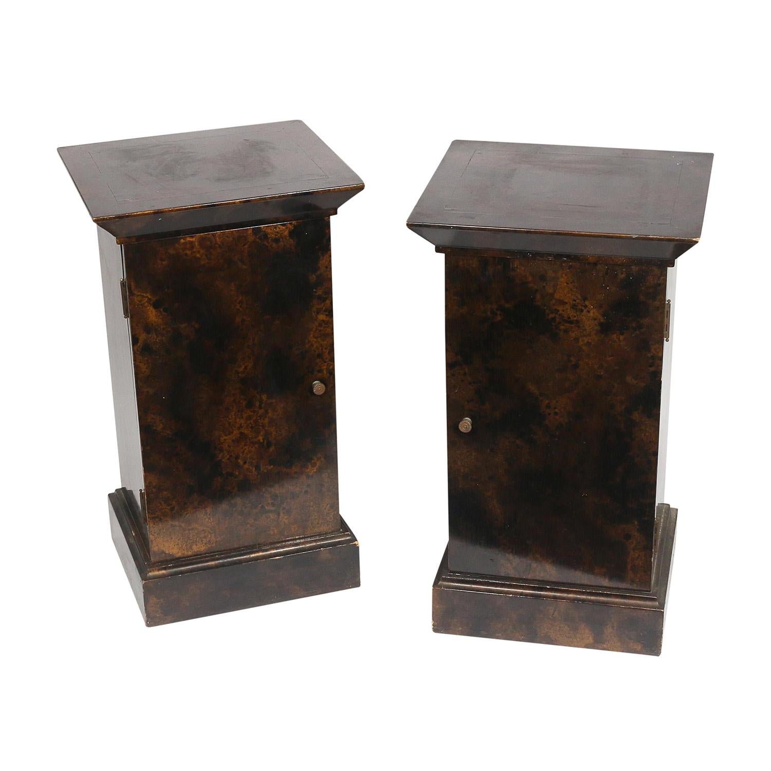 A vintage Mid-Century Modern American pair of cabinets made of hand carved lacquered burl wood, in good condition. The small, smokey bedside tables are composed with a single cabinet door, enhanced by unique wood carvings. Wear consistent with age