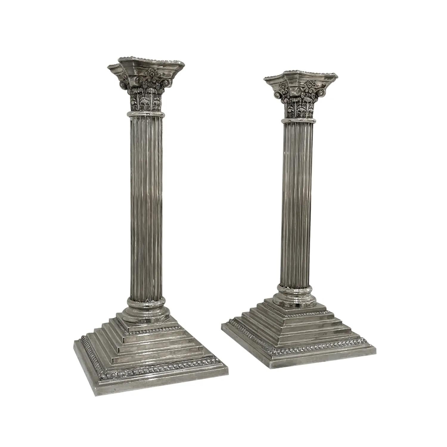A vintage late Mid-Century Modern American pair of candle holders made of hand crafted silver-plated metal, produced by Godinger in good condition. The candlesticks represent the Swedish Gustavian time period. Manufacturer label at the bottom. Dated