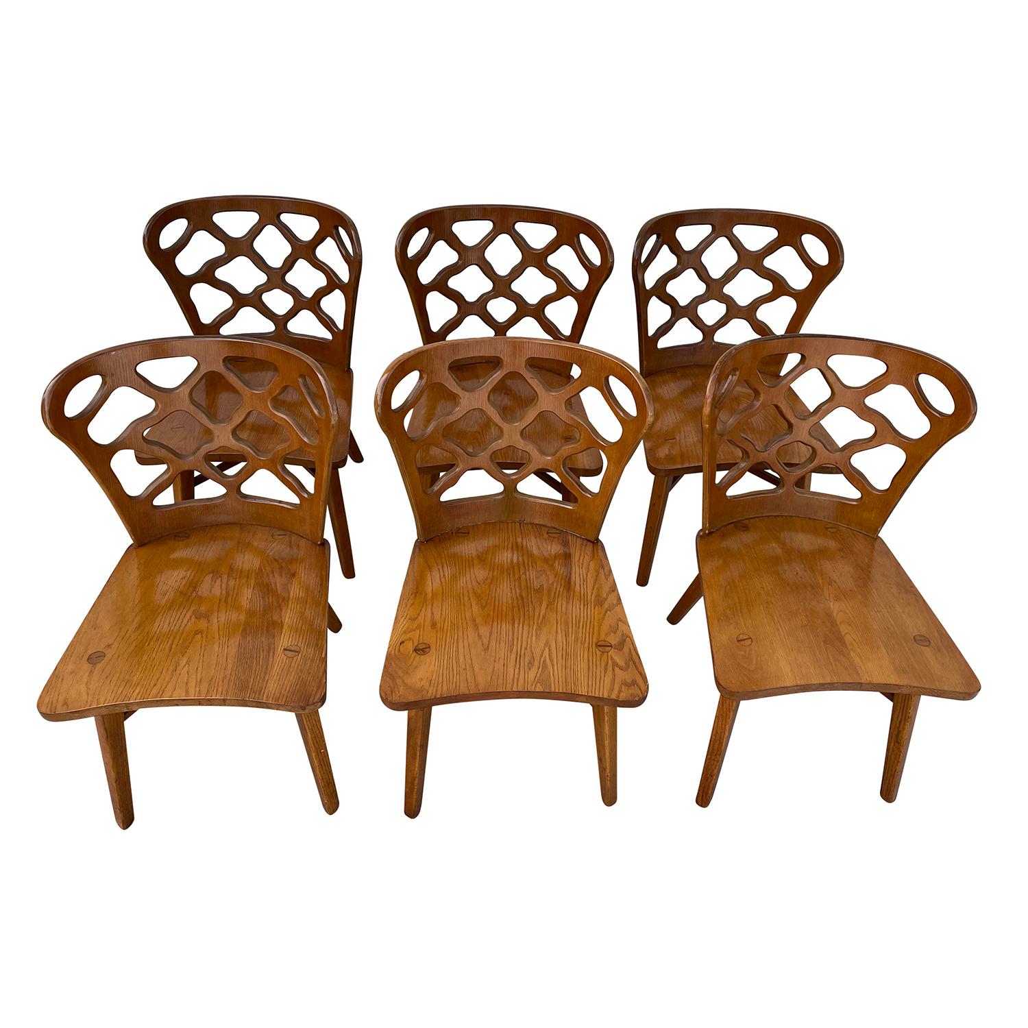 A dark-brown, vintage Mid-Century Modern American set of six dining chairs made of hand carved Oakwood and Bent Plywood, designed and produced by RomWeber in good condition. The back rest of each side chair is slightly curved to the inside with