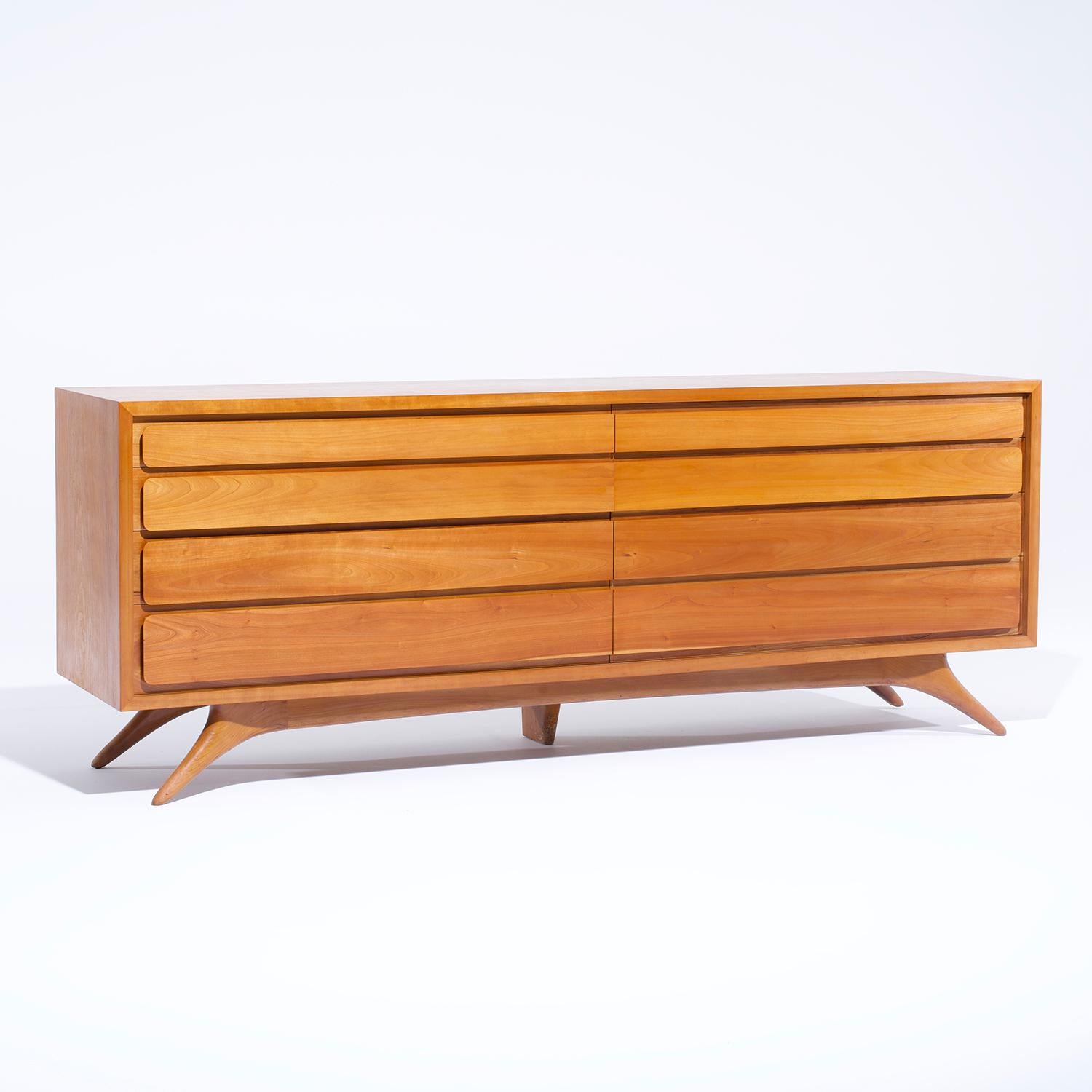 A rectangular, vintage Mid-Century modern American dresser made of hand crafted bleached Mahogany designed by Vladimir Kagan, in good condition. The partly polished sideboard is composed with eight large drawers. The interior consists of many