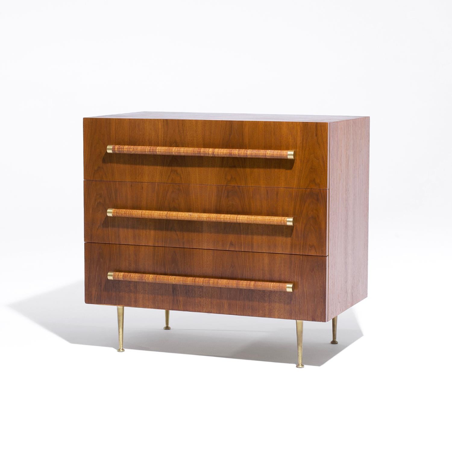 A single, vintage Mid-Century modern American dresser made of hand crafted polished Walnut designed by T.H. Robsjohn Gibbings and produced by Widdicomb, in good condition. The detailed chest is composed of three drawers enhanced by a long