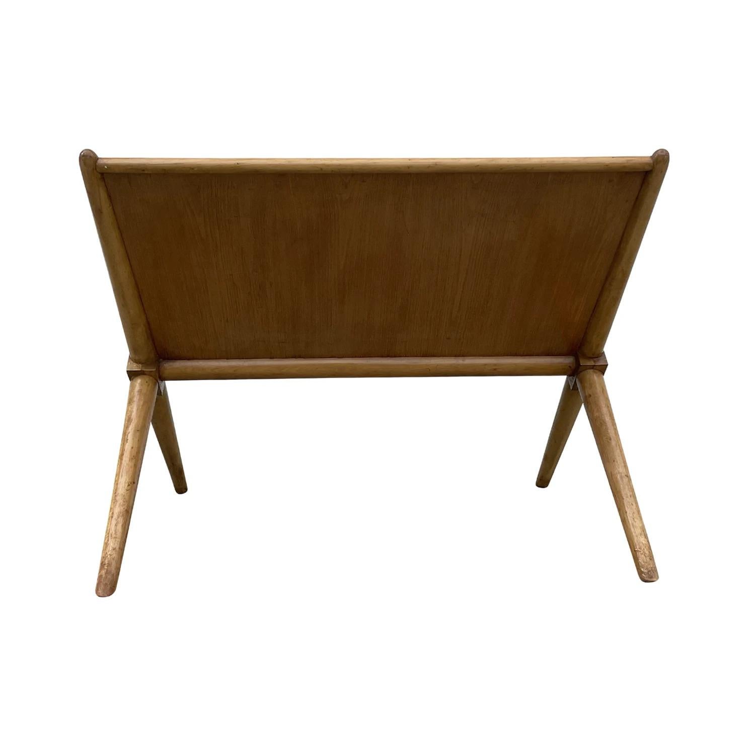 A light-brown, vintage Mid-Century Modern American X base magazine side table made of hand carved Mahogany and Birchwood, designed by Robsjohn-Gibbings and produced by Widdicomb, in good condition. The detailed end, sofa table has an arched top,