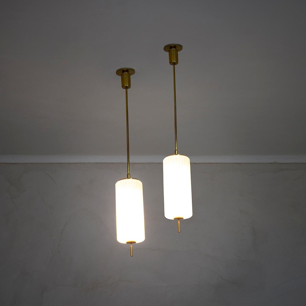 Couple of chandeliers designed by the italian master of Light: Angelo Lelii. For Arredoluce he designed in 1959 these chandeliers with a very simple and timeless shape: the structure is in Brass, the diffuser is in Opal Glass.
Good condition, fully