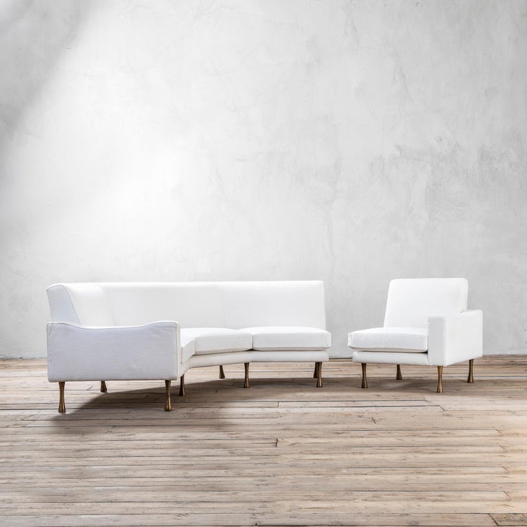 Sectional Sofa by Angelo Mangiarotti for La Sorgente dei Mobili designed in '70s. The sofa is composed of a corner sofa and an additional armchair. The structure is in wood, the feet are in brass, the cover is in white fabric. 
New