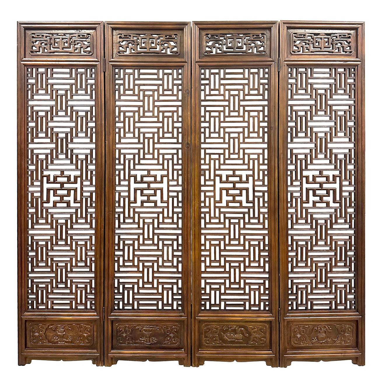 A set of four Chinese large carved wooden screen, with fretwork design, Created in China during mid 20th century, each of this set of four of large panels captures our attention with its carefully organized arrangement of fretwork motifs and