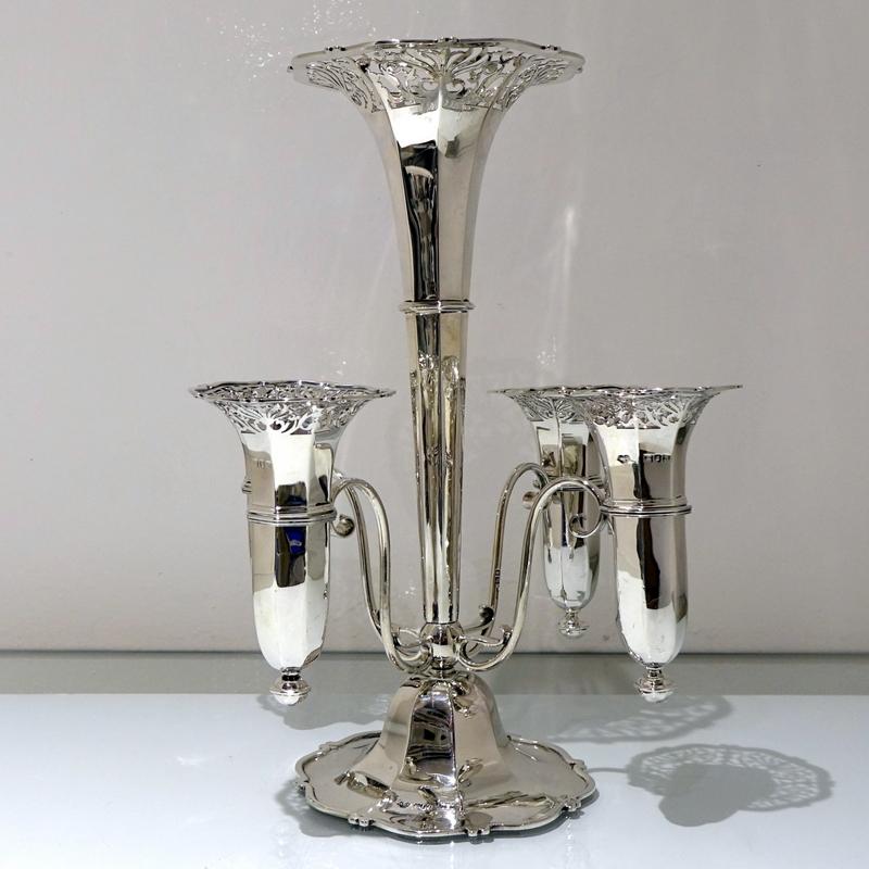 A highly desirable plain formed octagonal five basket “trumpet” epergne decorated with intricate floral piercing to the upper bowls/trumpets. The sheet wire arms and plain formed circular foot compliment the overall design.

 

Weight: 32 troy