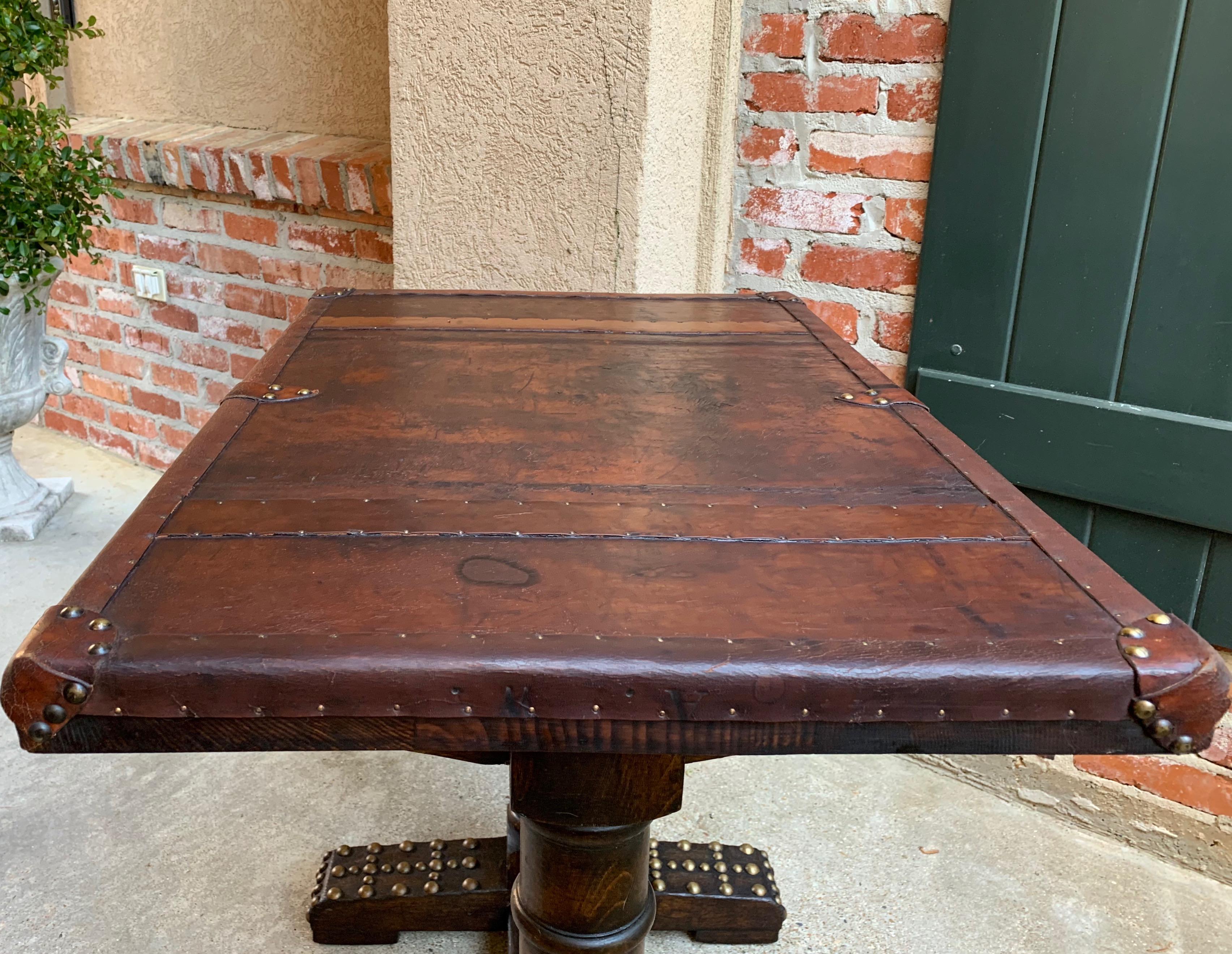 Direct from England, a charming antique English oak table or desk with aged leather top!~
~Gorgeous leather with brass tacks, and larger brass tacks on the wide plank feet~
~English thick turned legs with trestle style plank cross