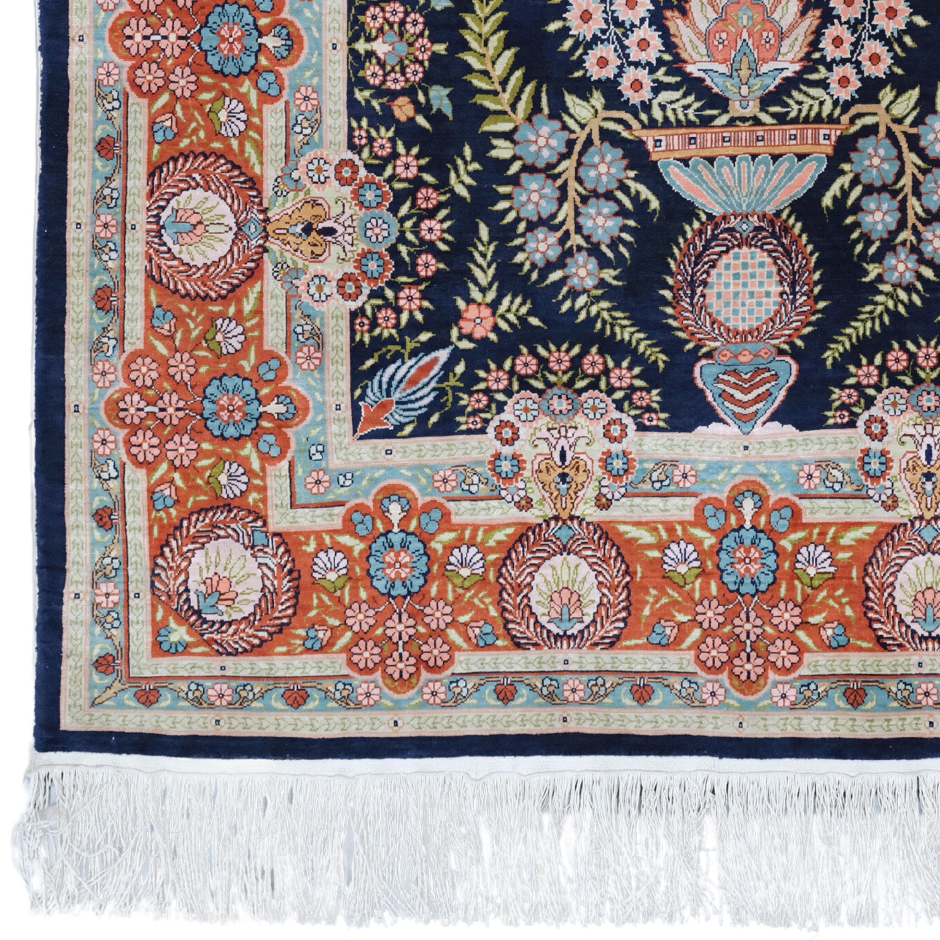 This 20th-century antique Persian Hereke silk carpet is both a masterpiece of textile art and a work that has survived the centuries. Fine workmanship, geometric patterns and motifs are embroidered on the fabric of this carpet. Each thread tells a