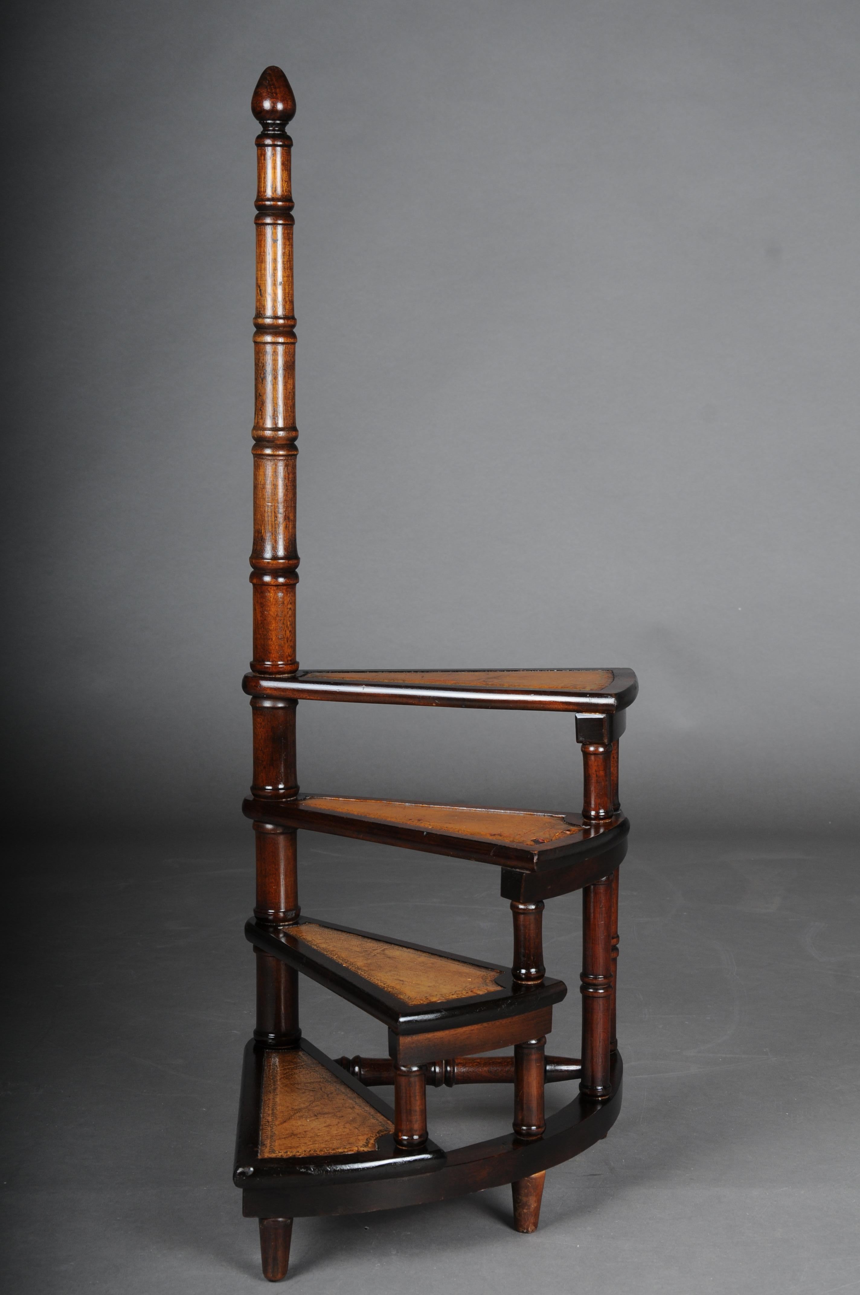 20th Century Antique library ladder/step ladder, mahogany England.

Solid wood covered with brown leather. four-stage with a long turned handle. Very stable and robust. Rare body shape. England 20th century.