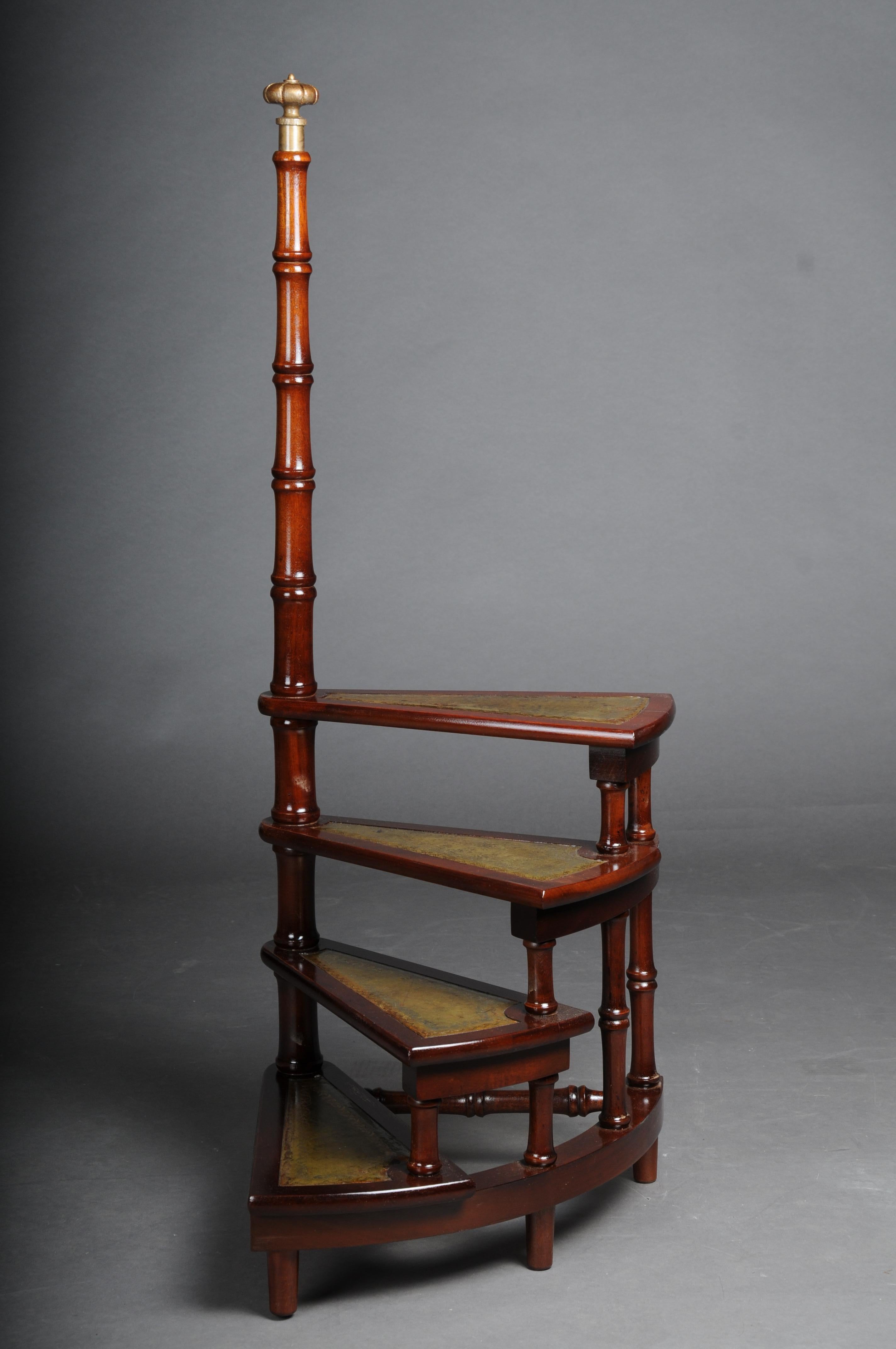 20th Century Antique library ladder/step ladder, mahogany England.

Solid wood covered with green leather. four-stage with a long turned handle. Very stable and robust. Rare body shape. England 20th century.