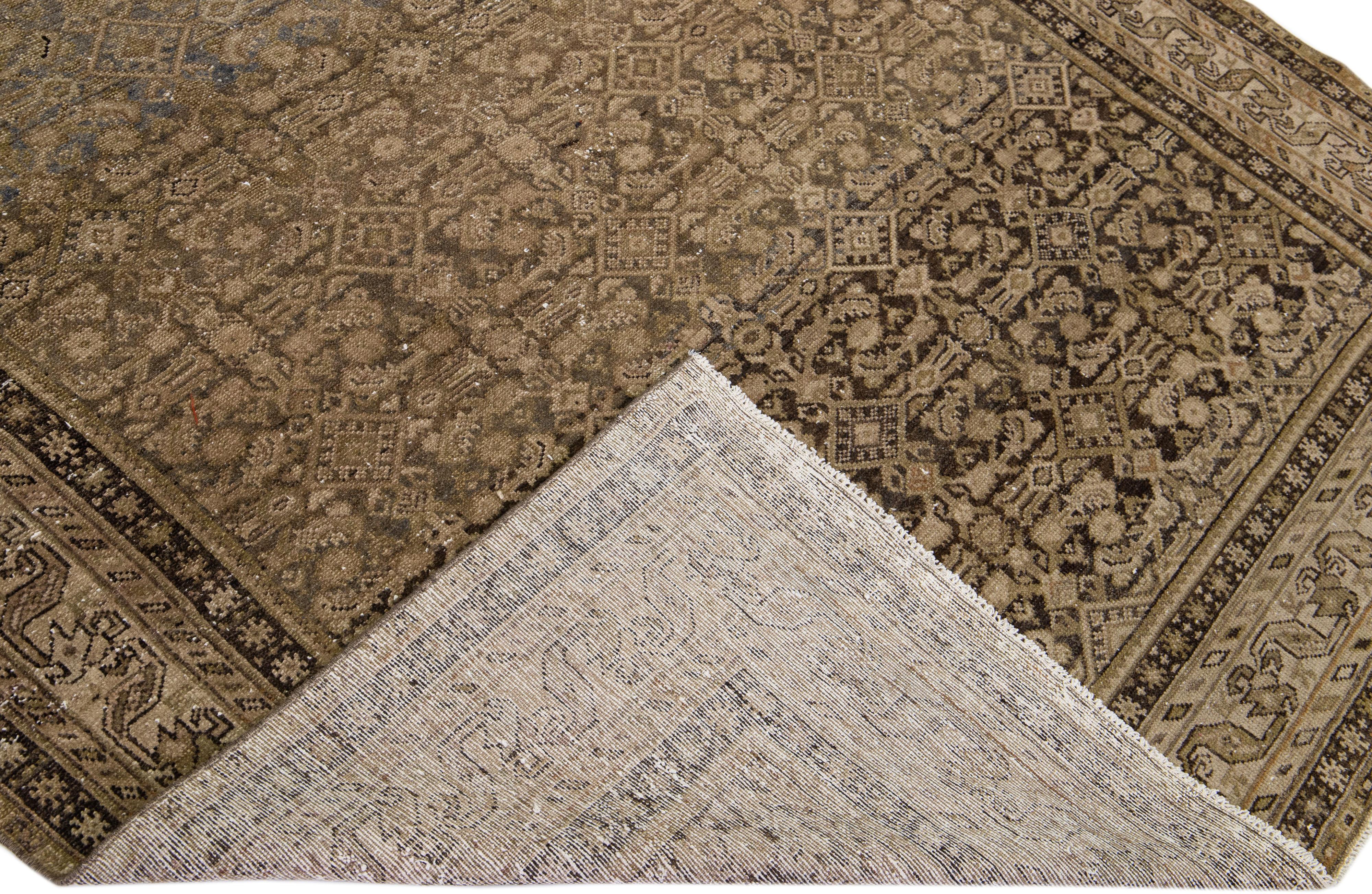Beautiful antique Malayer hand-knotted wool rug with a tan color field. This Malayer piece has a designed frame with brown accents in a gorgeous all-over geometric design.

This rug measures: 6'4