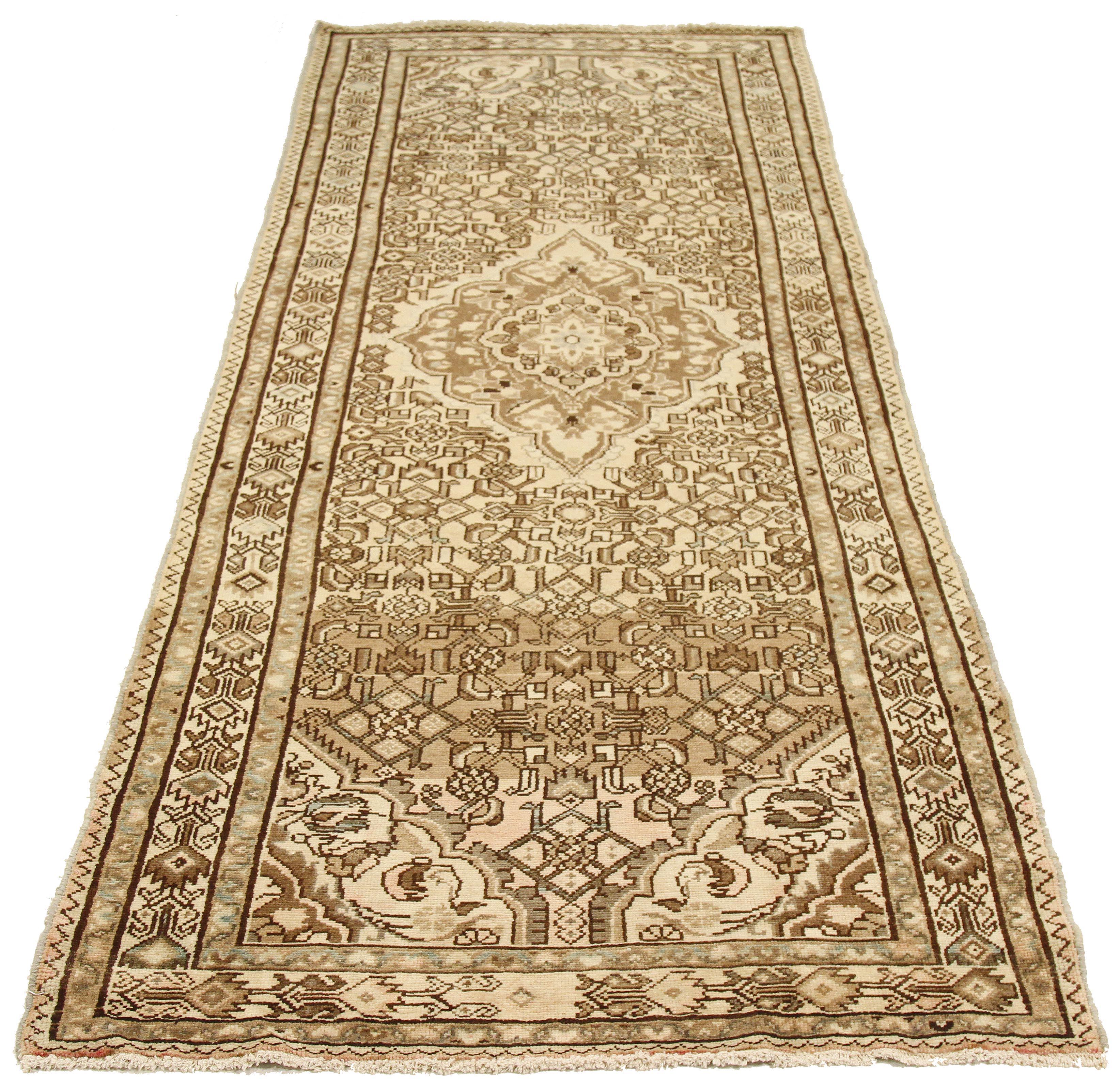 Antique Persian runner rug handwoven from the finest sheep’s wool and colored with all-natural vegetable dyes that are safe for humans and pets. It’s a traditional Malayer design featuring brown and gray floral details over an ivory field. It’s a