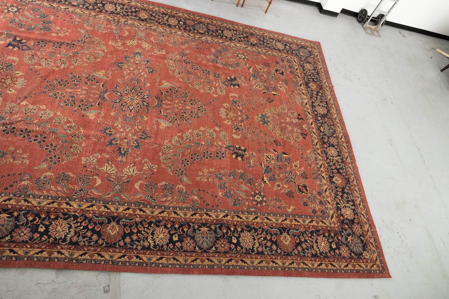 A caucasian rug in rust and blue tones, circa early 20th century.
 
