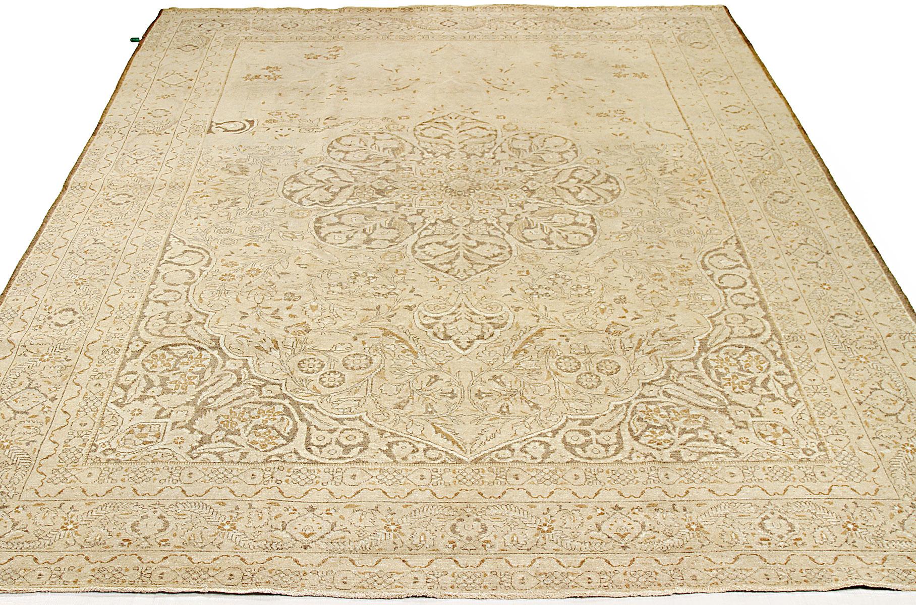 Antique Persian rug handwoven from the finest sheep’s wool and colored with all-natural vegetable dyes that are safe for humans and pets. It’s a traditional Tabriz weaving featuring a lovely ensemble of floral designs in black and brown over an
